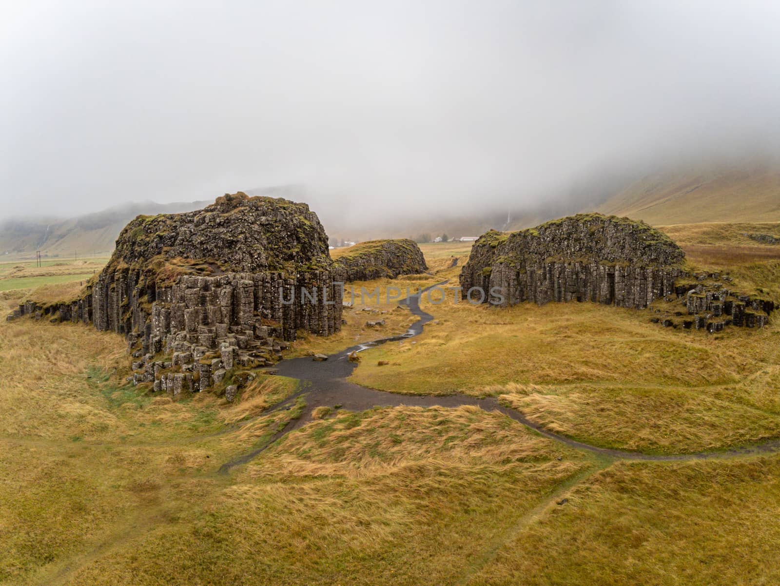 Dverghamrar dwarf hammer natural basalt columns covered in grass and moss landscape in southern Iceland