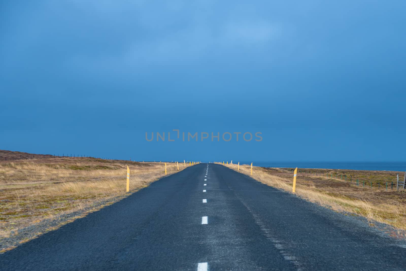 Empty coast road in Iceland during grey and stormy autumn day