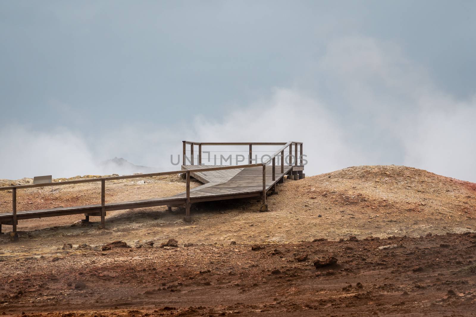 Geo Thermal hot spring activity in Iceland Gunnuhver Hot Springs wooden walkway by MXW_Stock