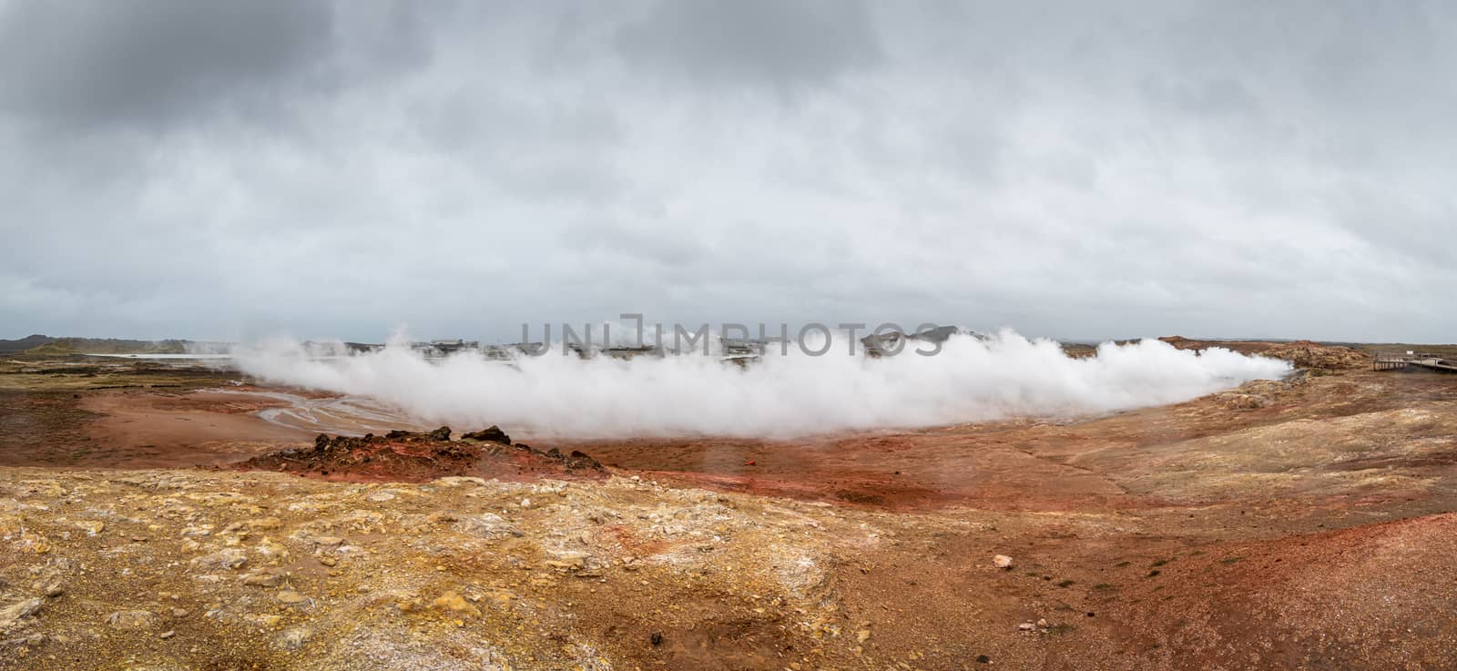 Geo Thermal hot spring activity in Iceland Gunnuhver Hot Springs steam cloud blown horizontally away