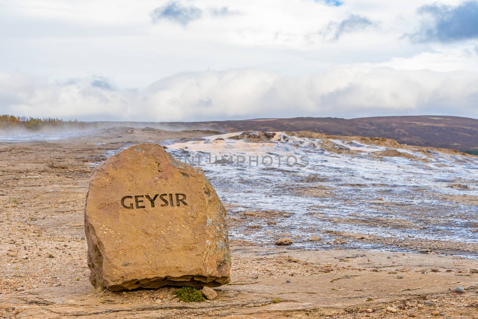 Geysir Golden Circle in Iceland name cut in rock in front of geothermal area by MXW_Stock