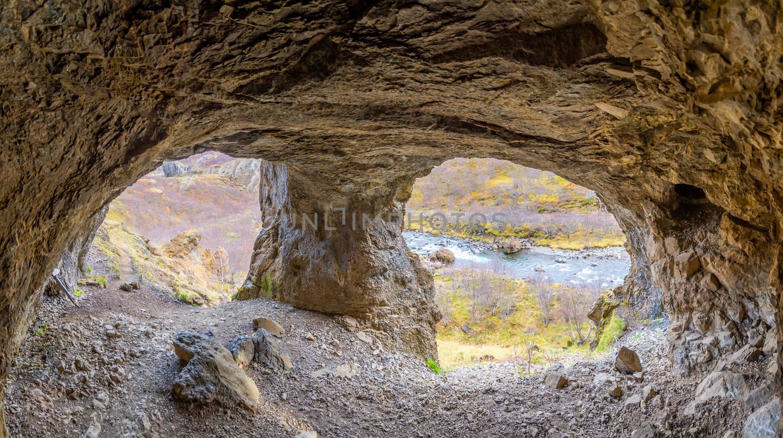 Glymur waterfall in Iceland cave leading towards river on the way to the fall by MXW_Stock