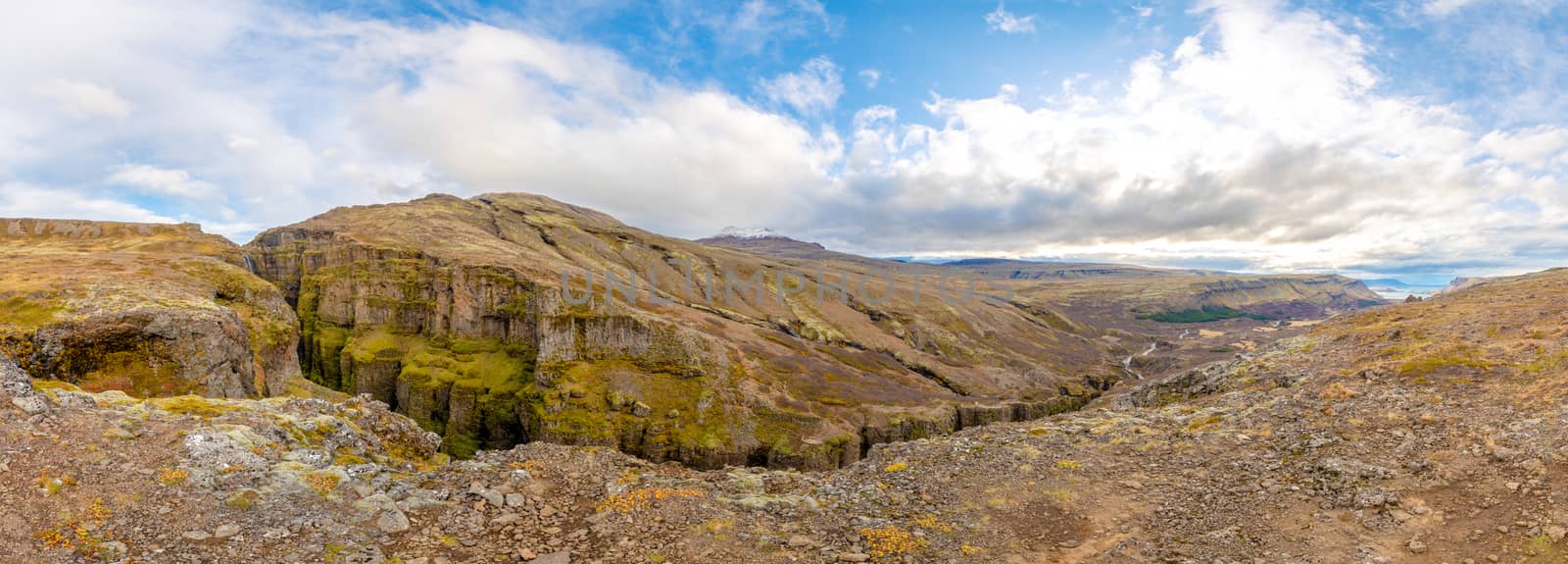 Glymur waterfall in Iceland panorama of gorge behind fall and river leading down to the lake