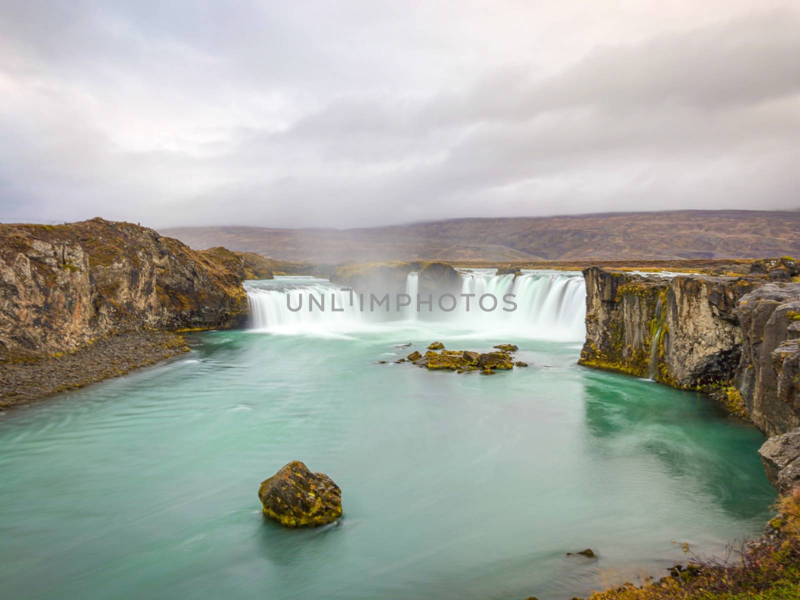 Godafoss waterfall in Iceland long exposure during rainy weather by MXW_Stock