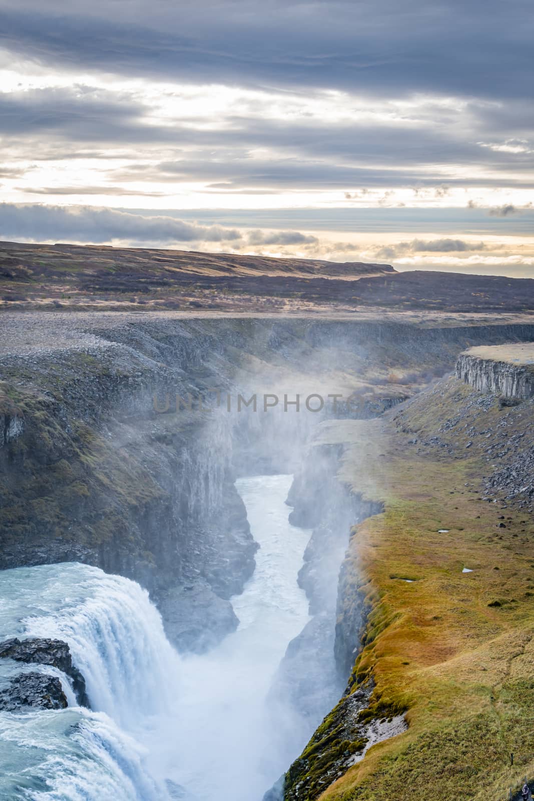 Gullfoss waterfall in Iceland deep canyon cut in landscape by the water by MXW_Stock