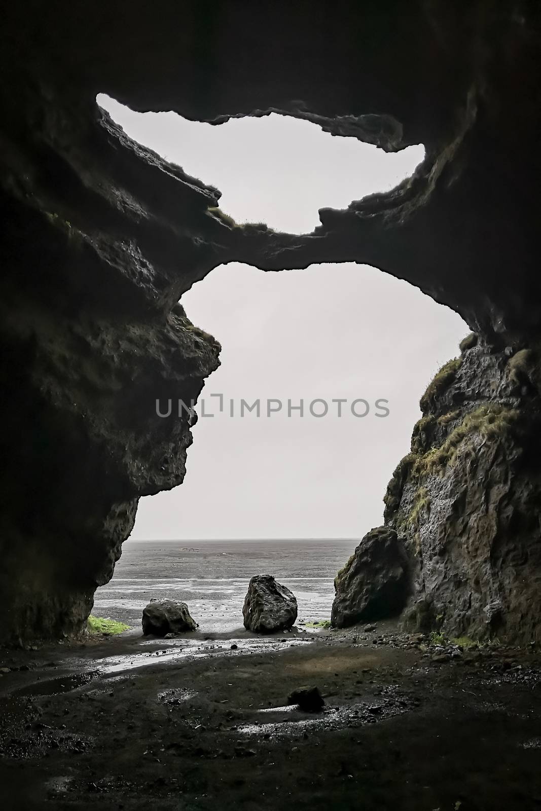 Hjoerleifshoefdi Cave in Iceland from inside cave entrance in shape of master yoda by MXW_Stock