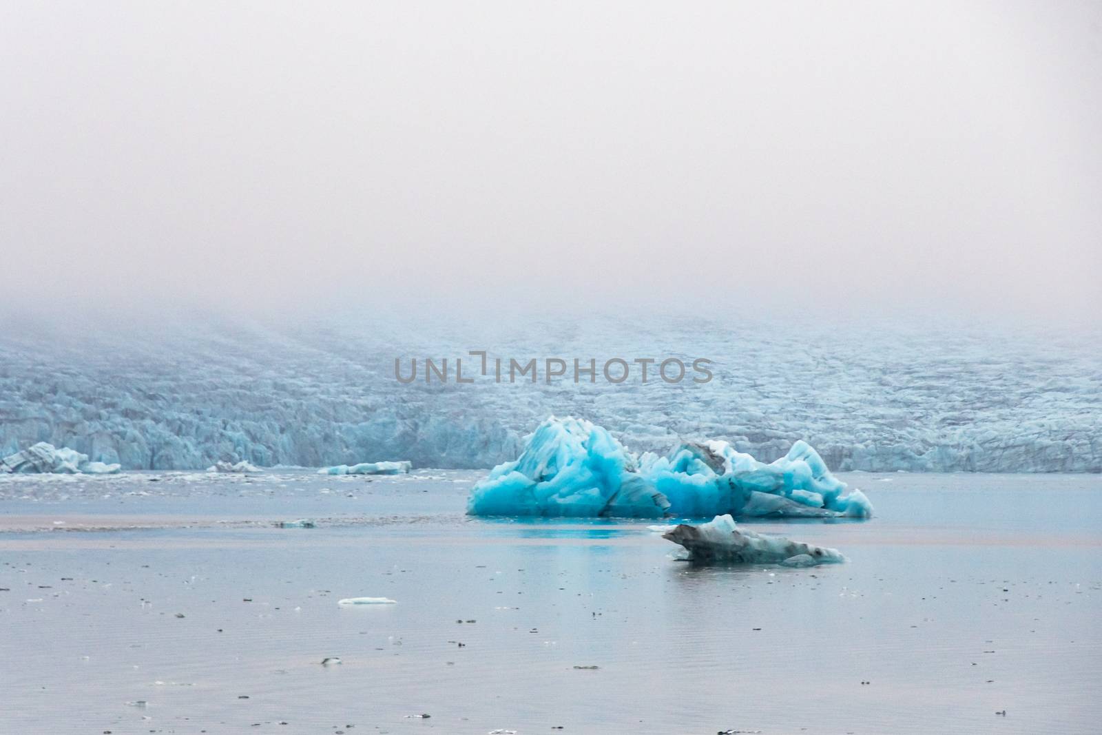Joekulsarlon Glacier Lagoon iceberg calving from Vatnajoekull glacier by MXW_Stock