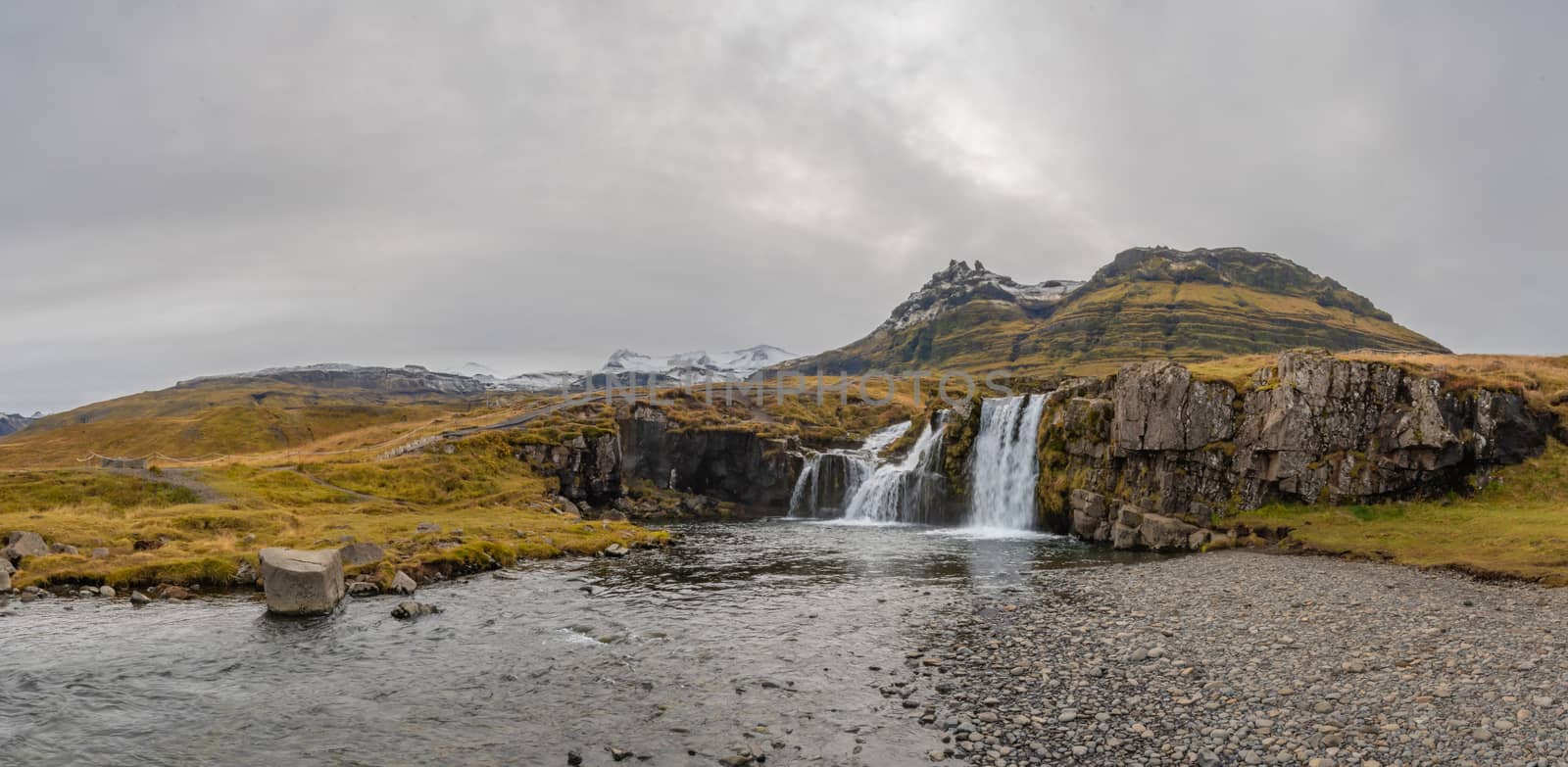 Kirkjufell in Iceland Kirkjufellsfoss waterfall panorama of complete setting by MXW_Stock