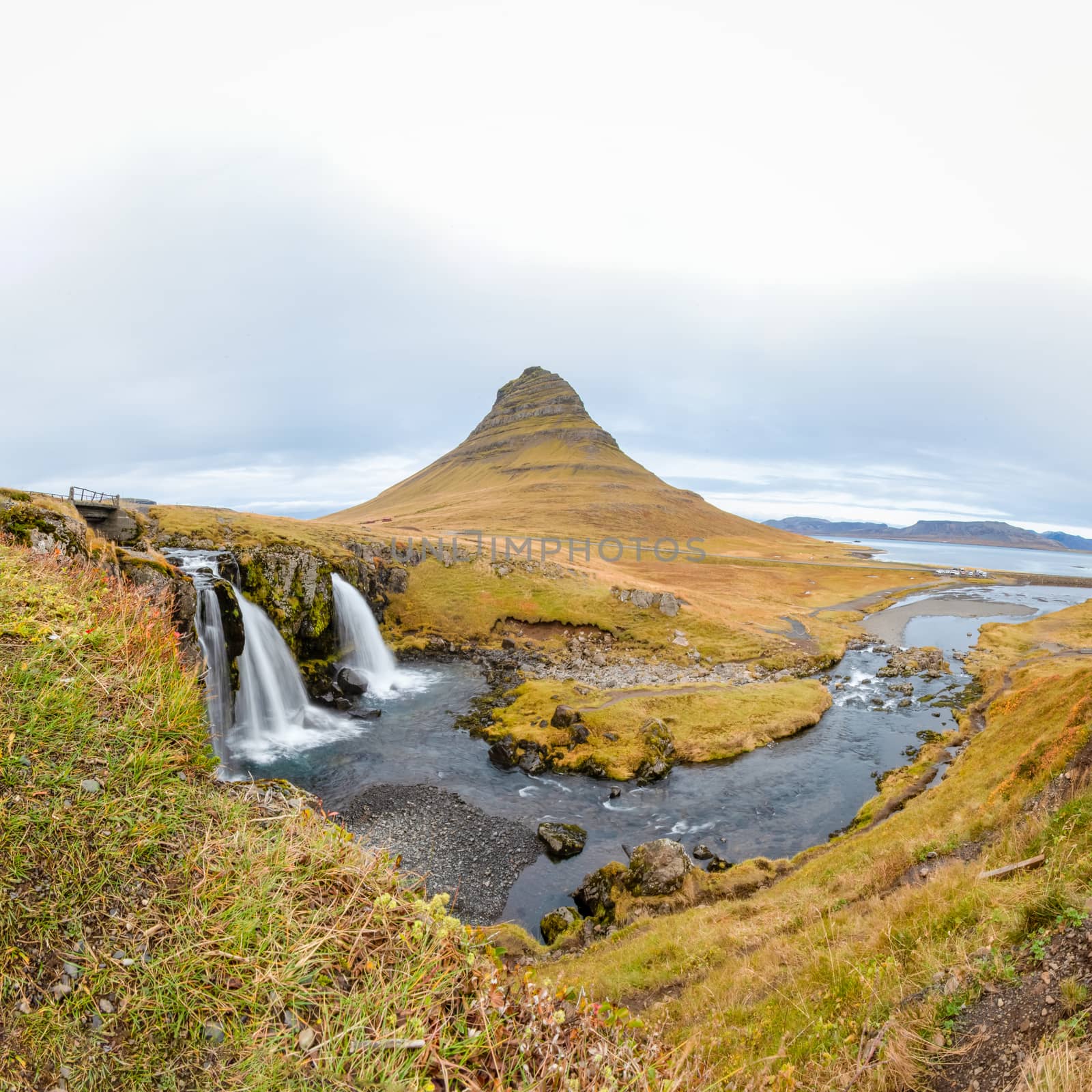 Kirkjufell in Iceland Kirkjufellsfoss waterfall square panorama of fall and famous mountain by MXW_Stock
