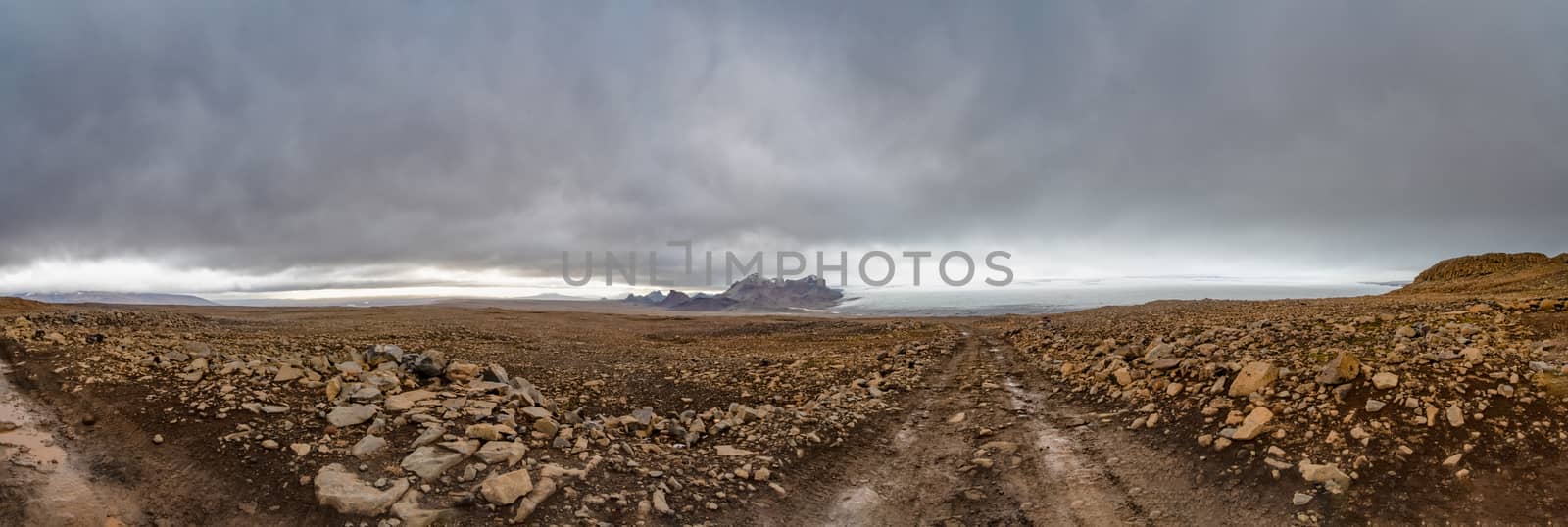 Langjokull Glacier behind huge muddy and rocky wasteland in the heart of iceland by MXW_Stock