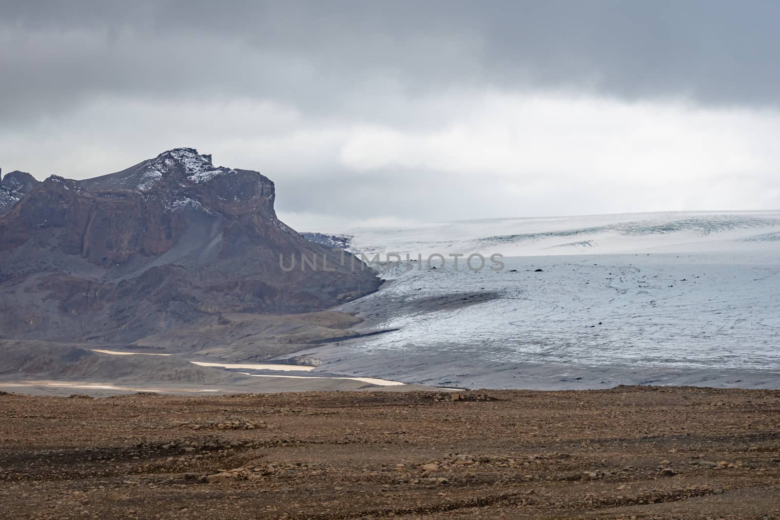 Langjokull Glacier view over bald rock land towards the white ice giant by MXW_Stock