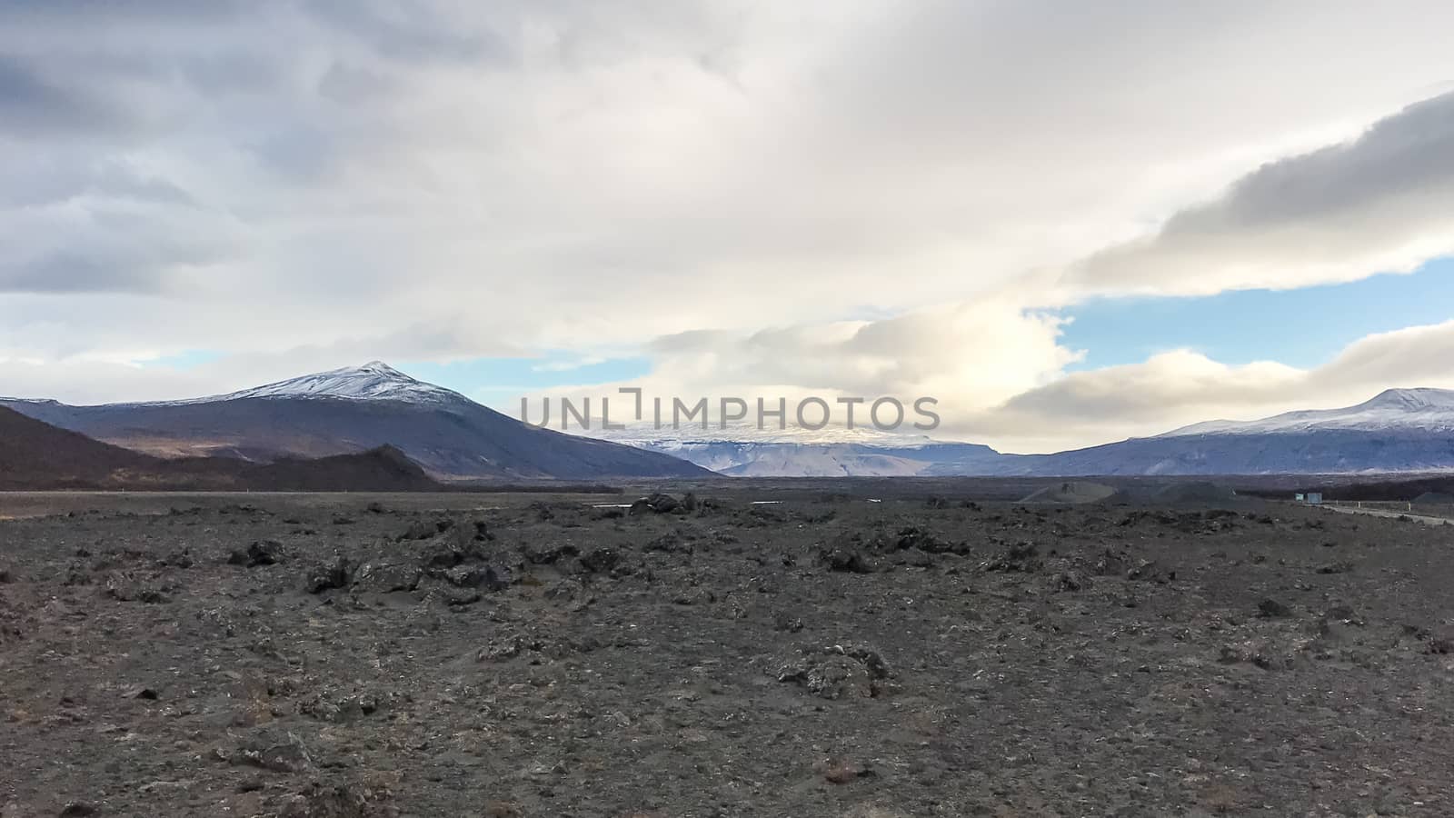 Lava field in front of snow covered mountain tops in central Iceland