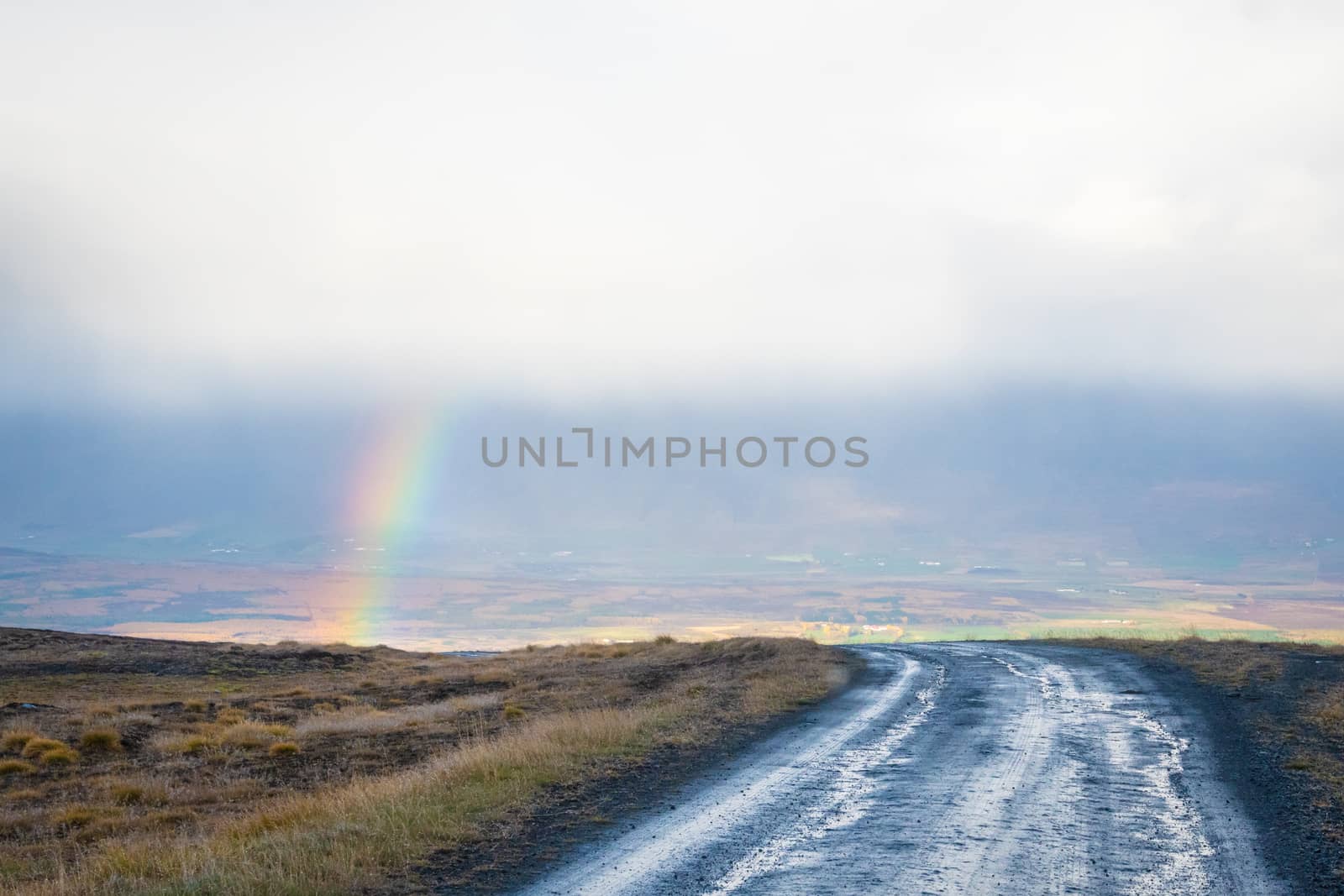 Mountain pass towards Akureyri in Iceland rainbow appearing in valley by MXW_Stock