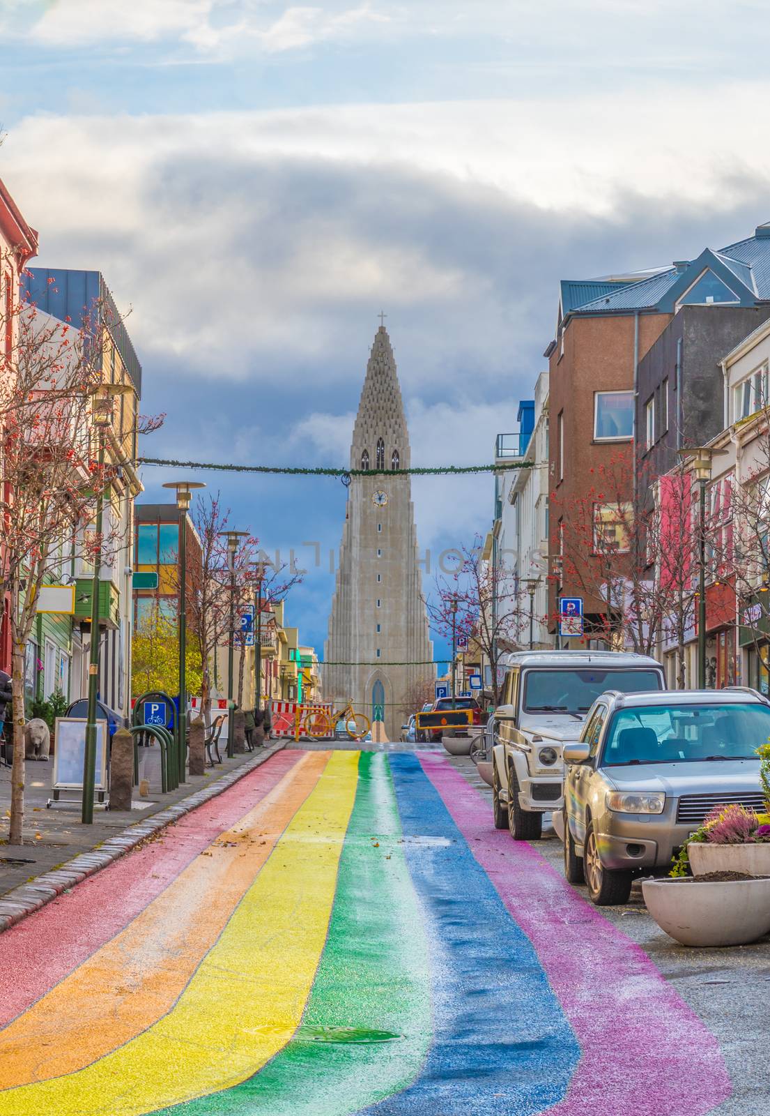 Reykjavik in Iceland rainbow LBGT colored street Skolavoerdustigur street in front of Hilgrimskirkja Hilgims church by MXW_Stock