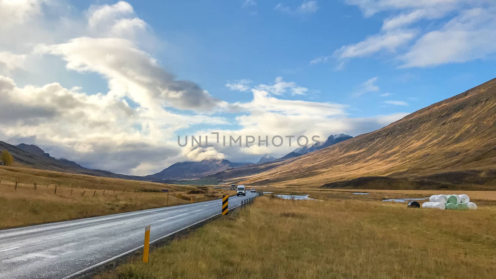 Road in northern Iceland leading through valley during sunshine by MXW_Stock