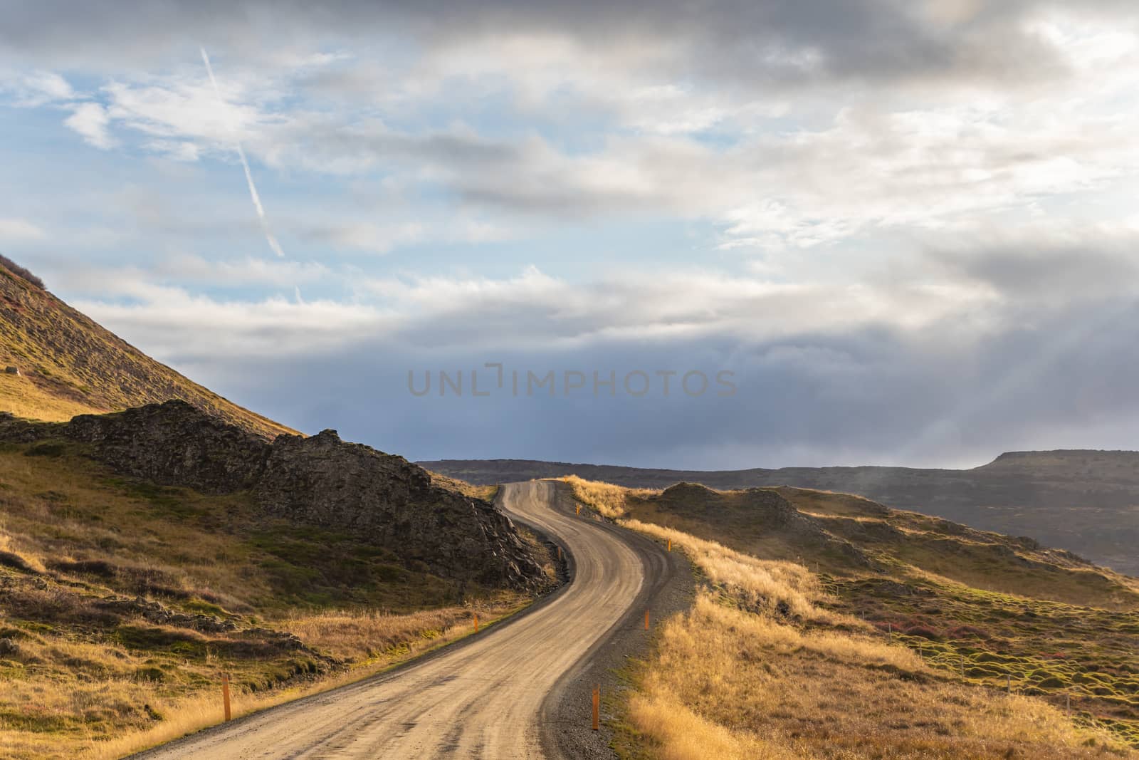Road trip in Iceland dirt road in west iceland winding along atlantic coast during beautiful sunshine
