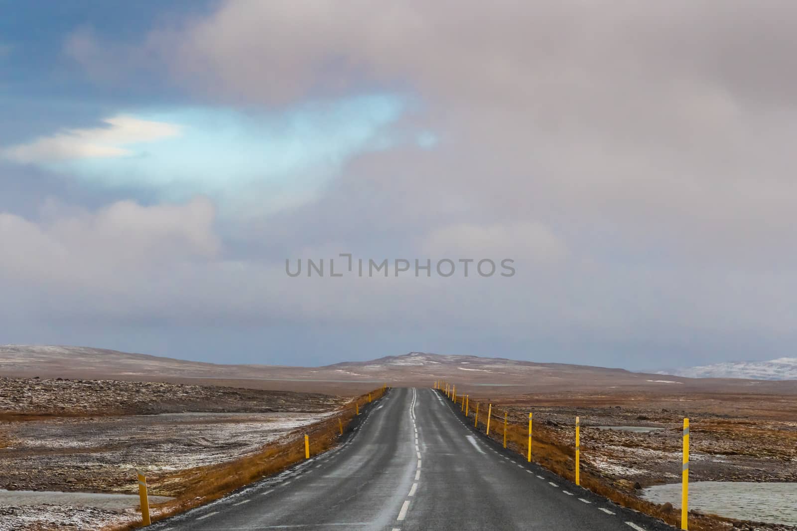 Road trip in Iceland driving over mountain pass after first snow clouds opening up