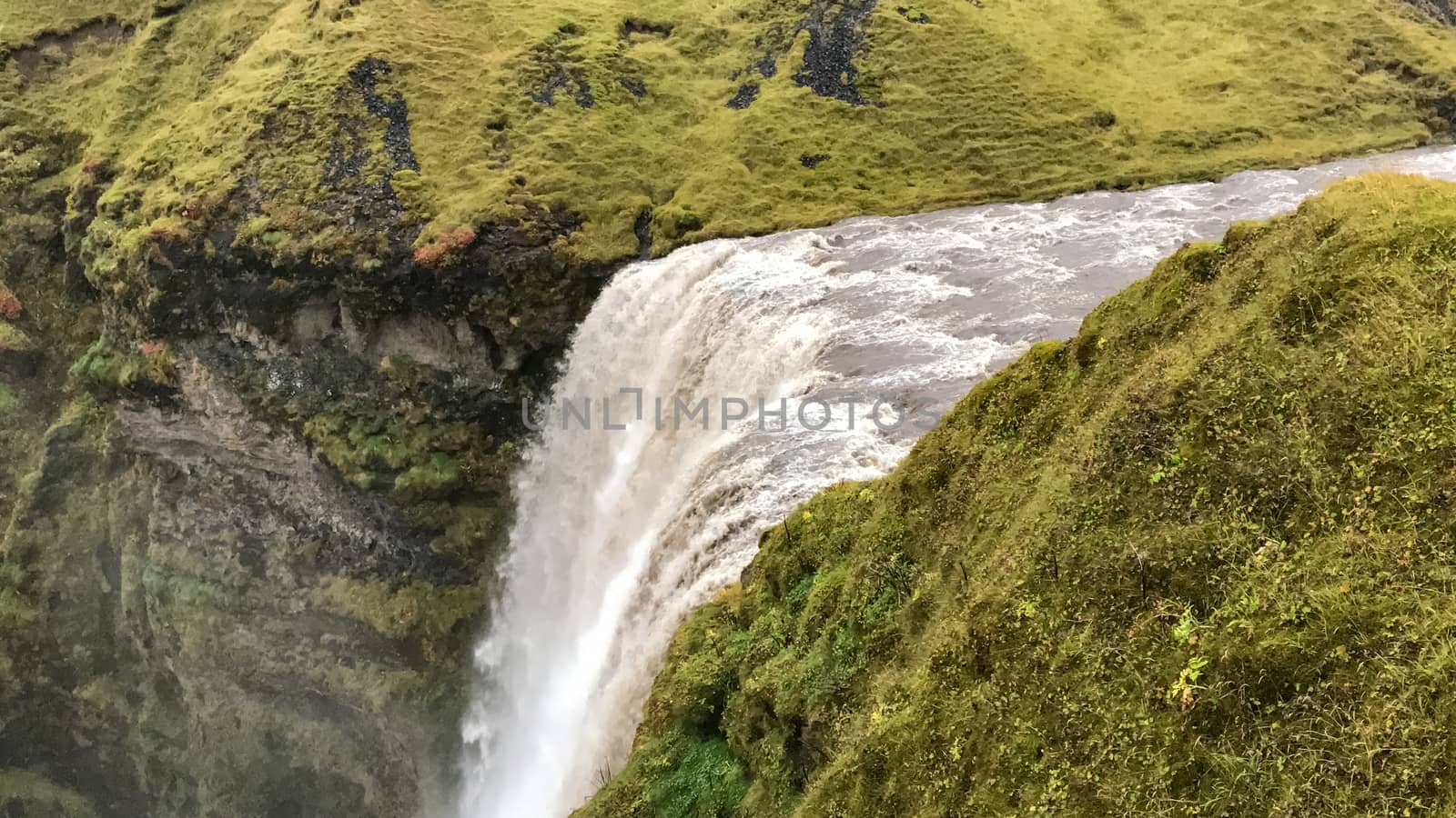 Skogafoss waterfall in Iceland during heavy rain seen from above
