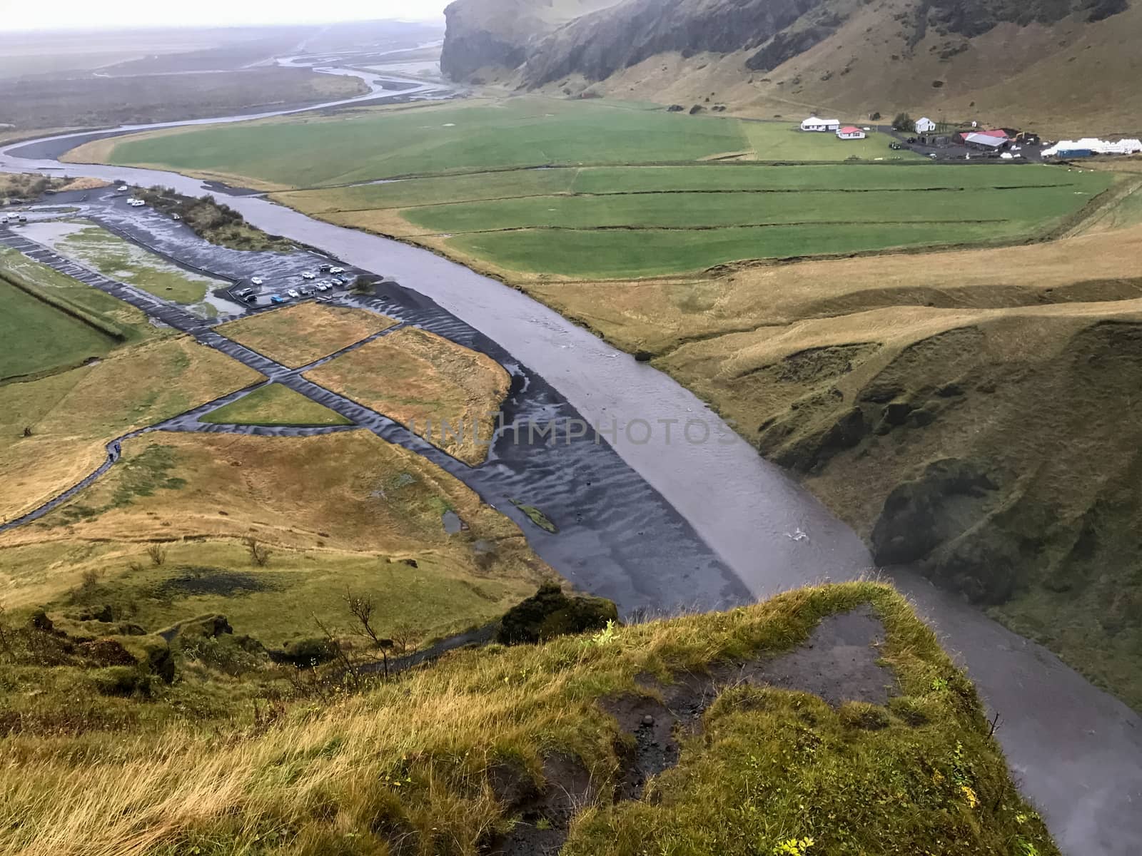 Skogafoss waterfall in Iceland river behind waterfall during heavy rainfall seen from above by MXW_Stock