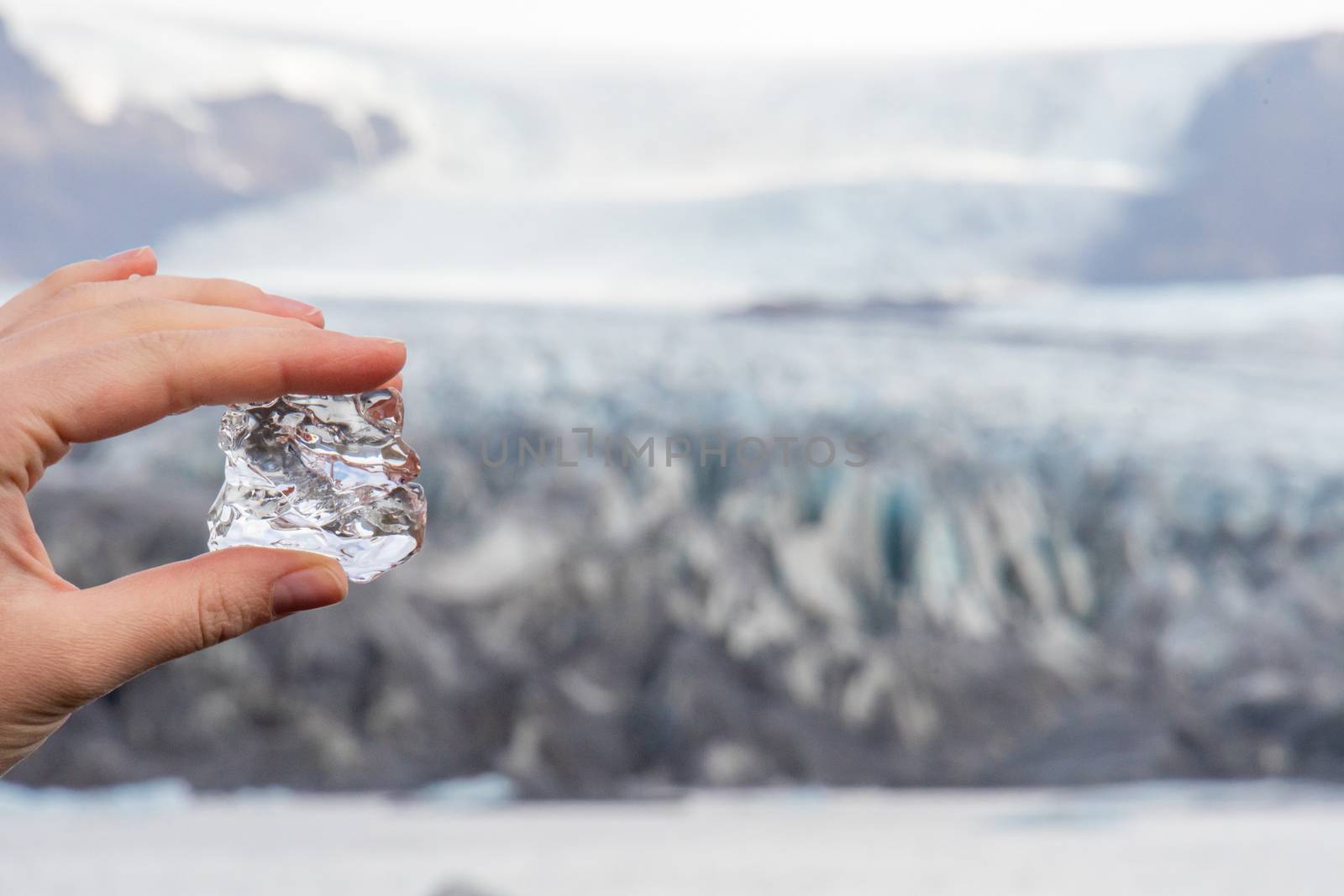 Vatnajoekull glacier in Iceland ice of the glacier between fingers in front of the deep blue ice crevices by MXW_Stock