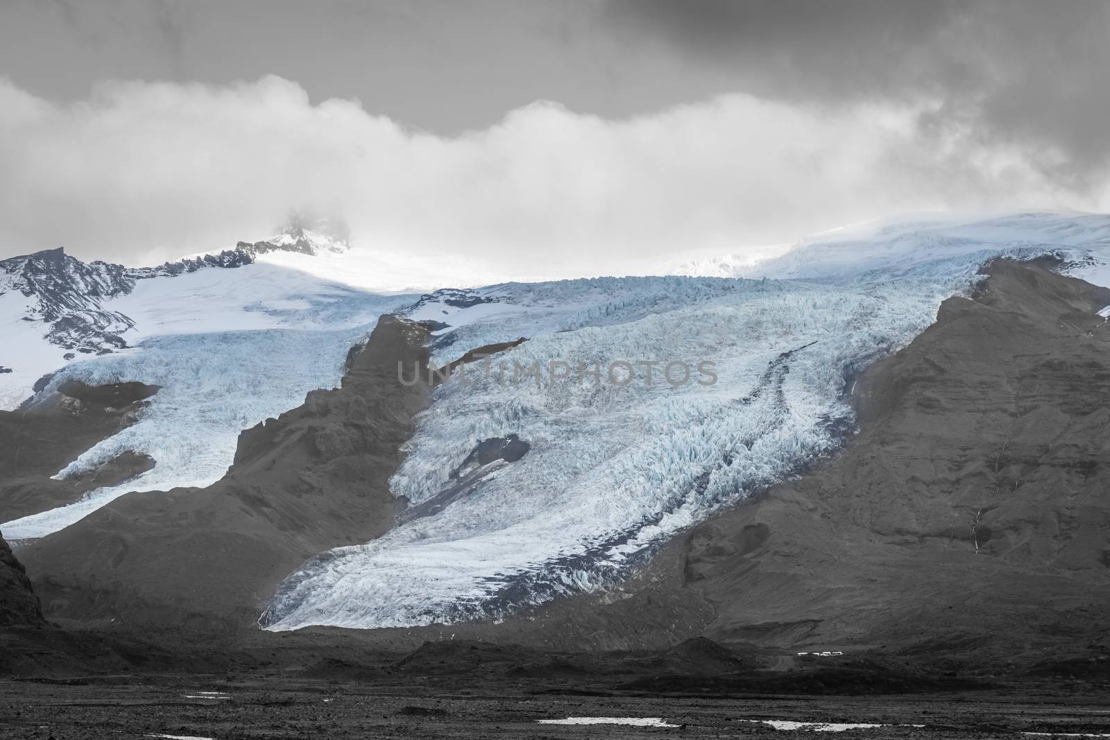 Vatnajoekull glacier in Iceland spiky crevasse in black and white with blue accent colored ice shield