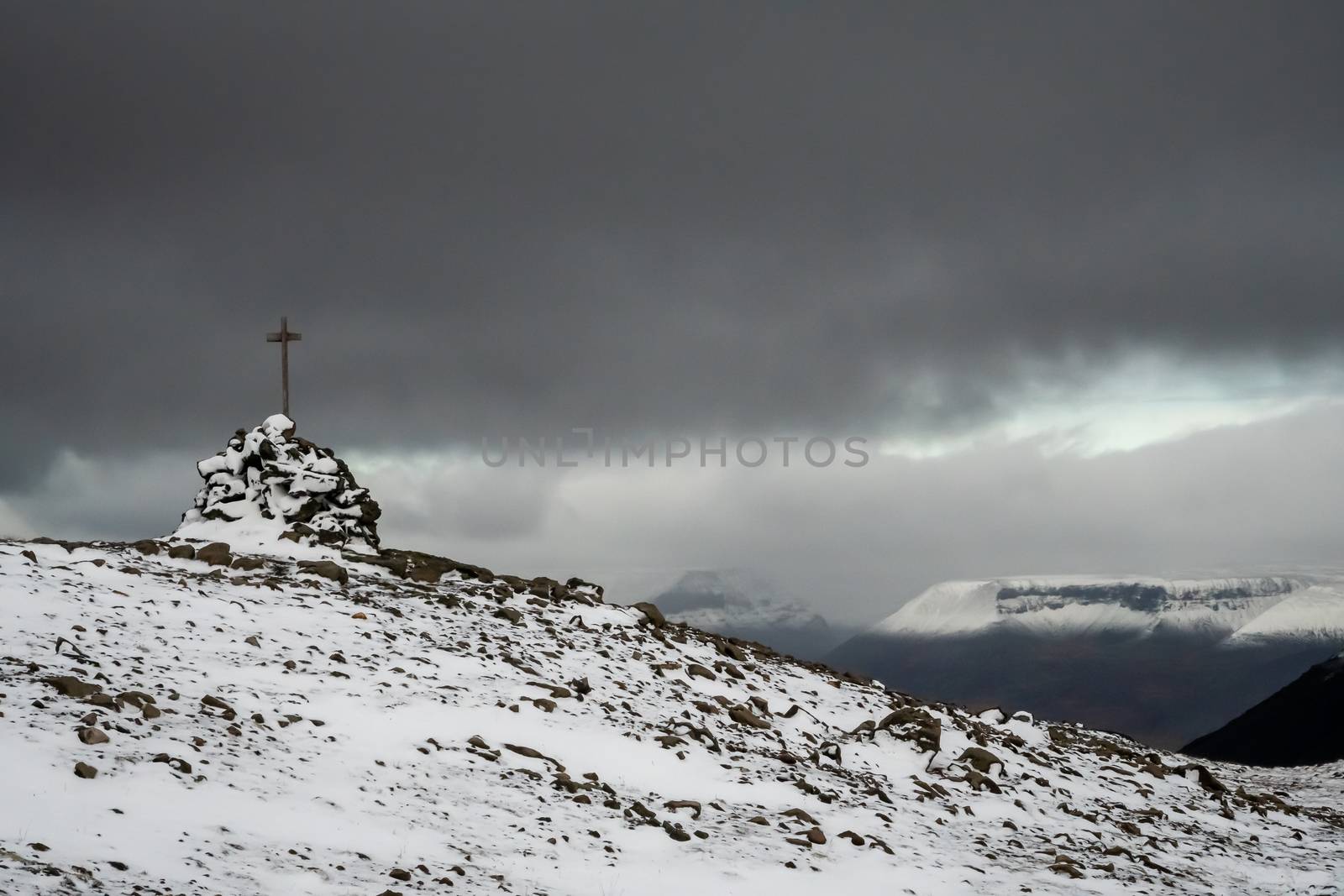 West fjords of Iceland summit cross covered in snow