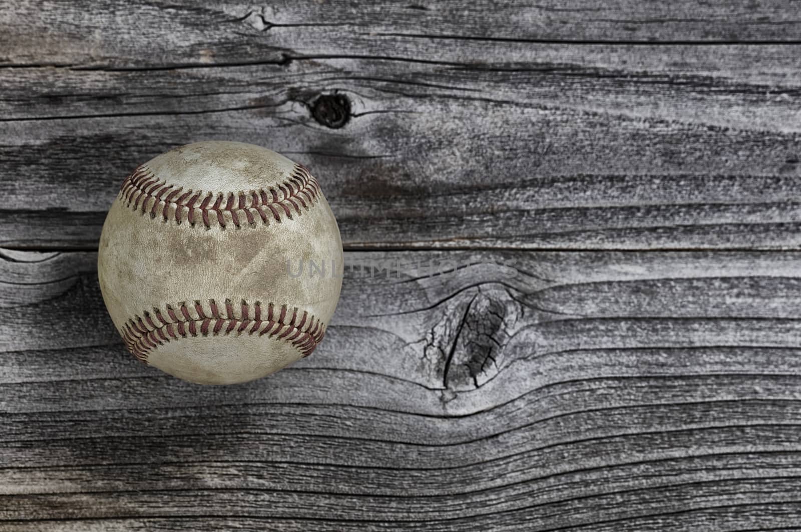 Single used baseball on vintage wooden background. Baseball spor by tab1962