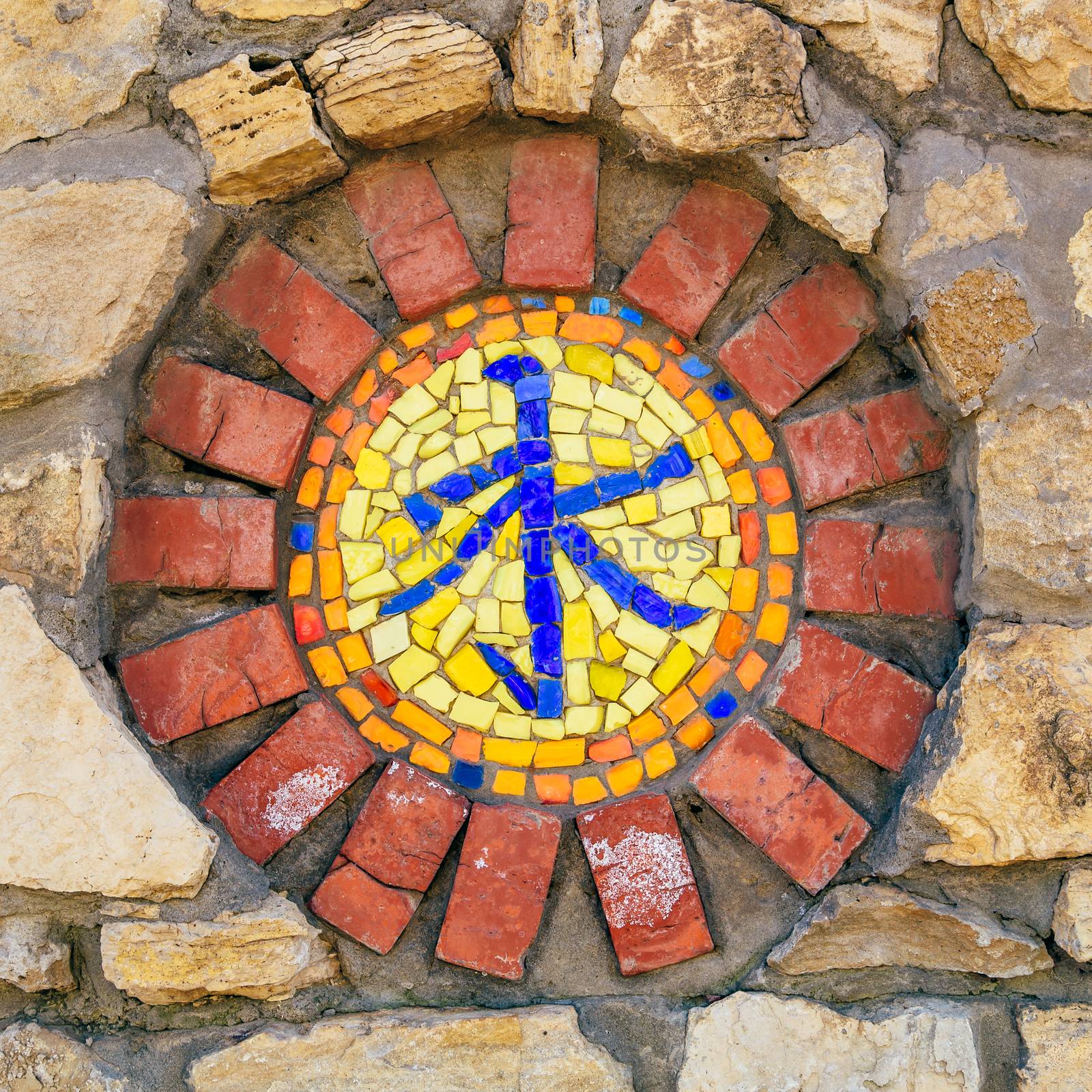 Circular mosaic religious symbol of confucianism on stone wall.