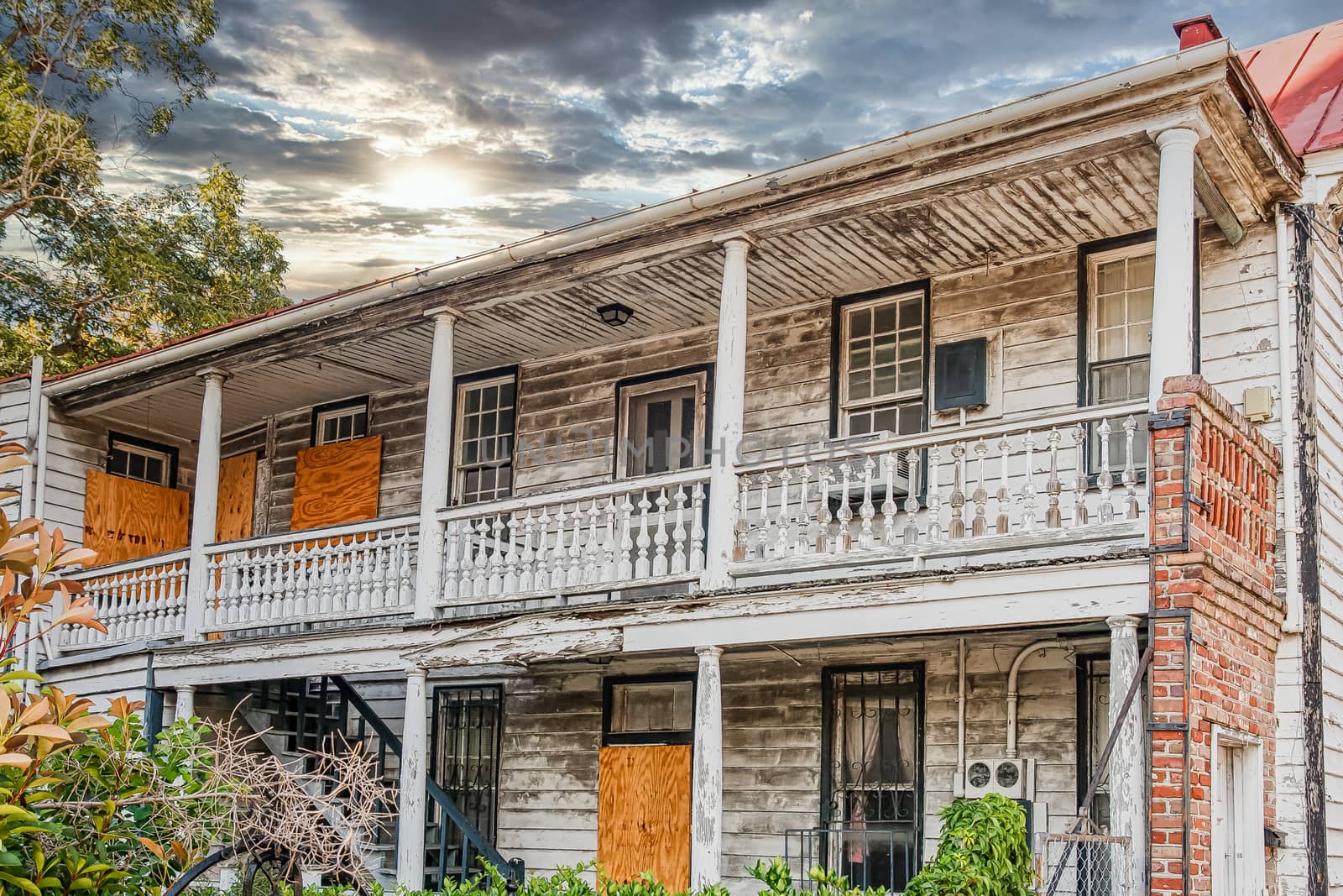 Old abandoned house with boarded up doors and peeling paint