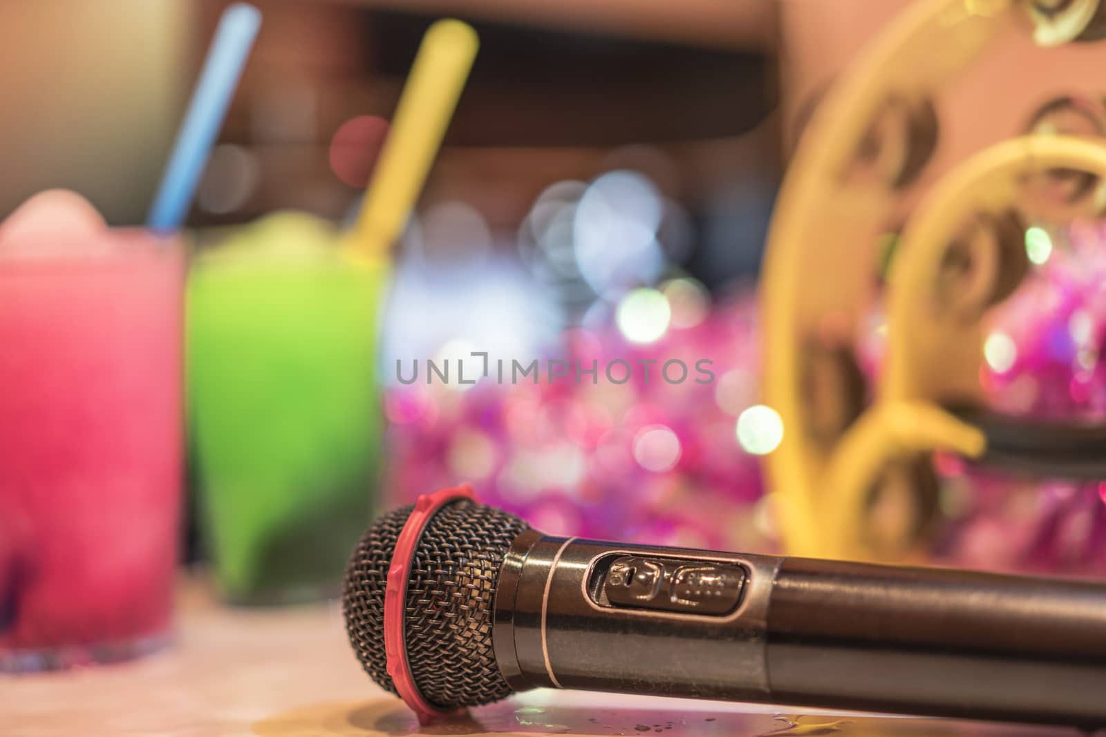Black microphone in karaoke club, with remote controller by kuremo