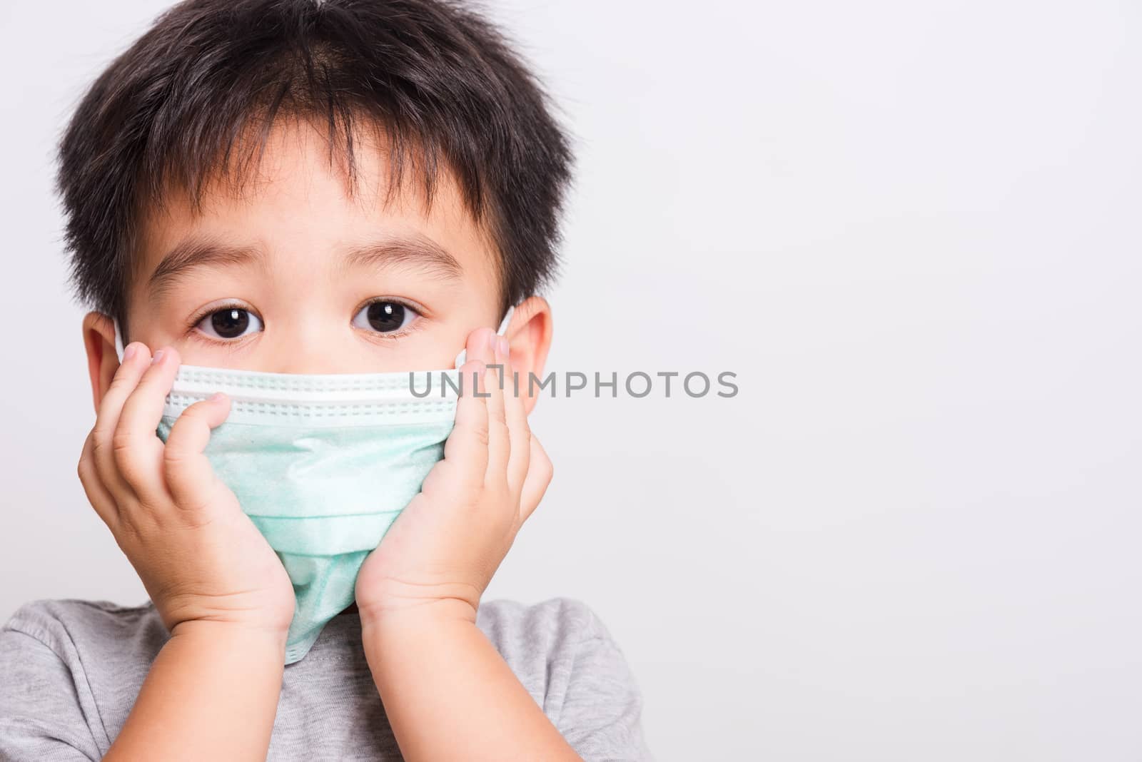 Closeup Asian face, Little children boy sick he using medicine healthcare mask on white background with copy space, health medical care