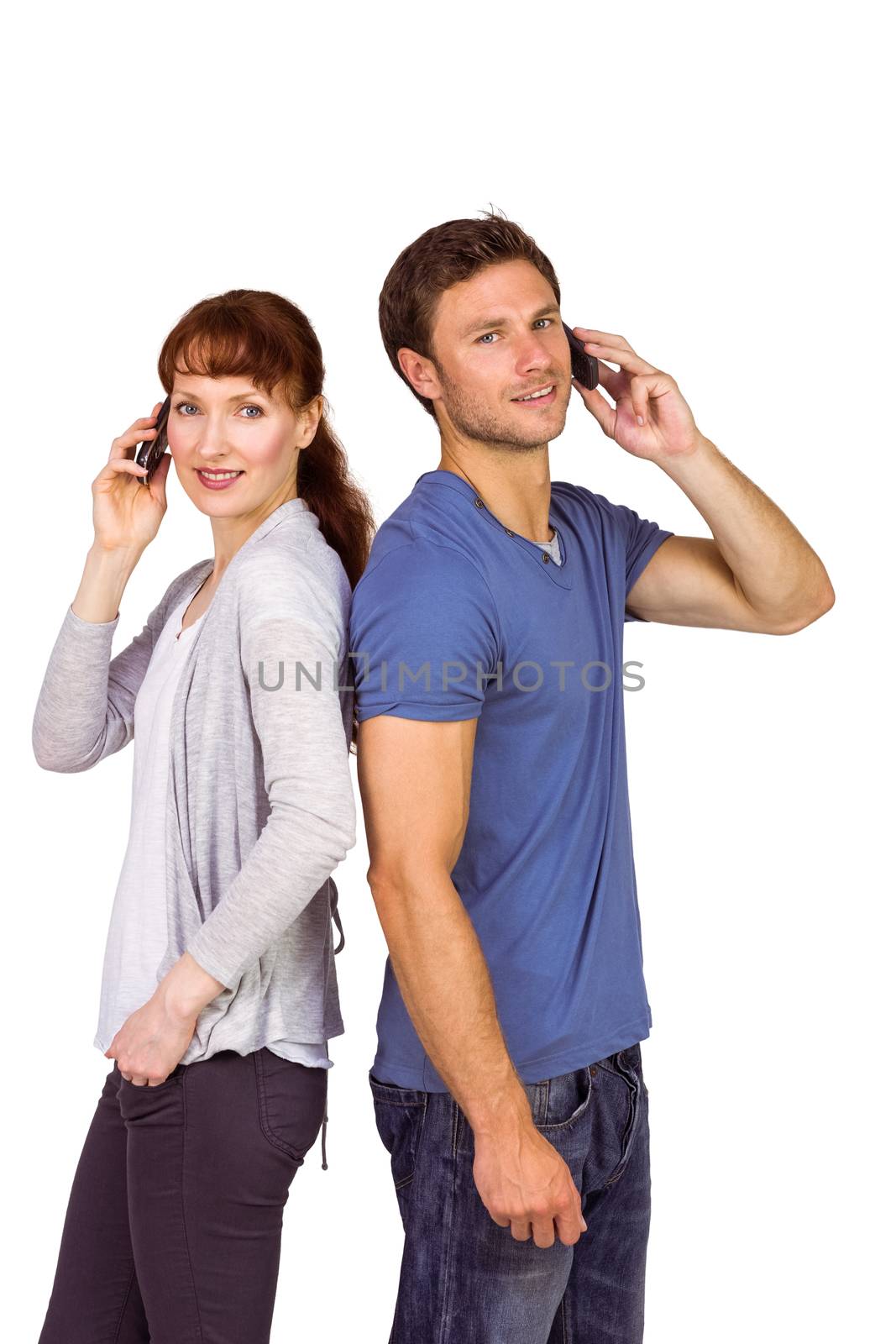 Couple both making phone calls on their mobile phones