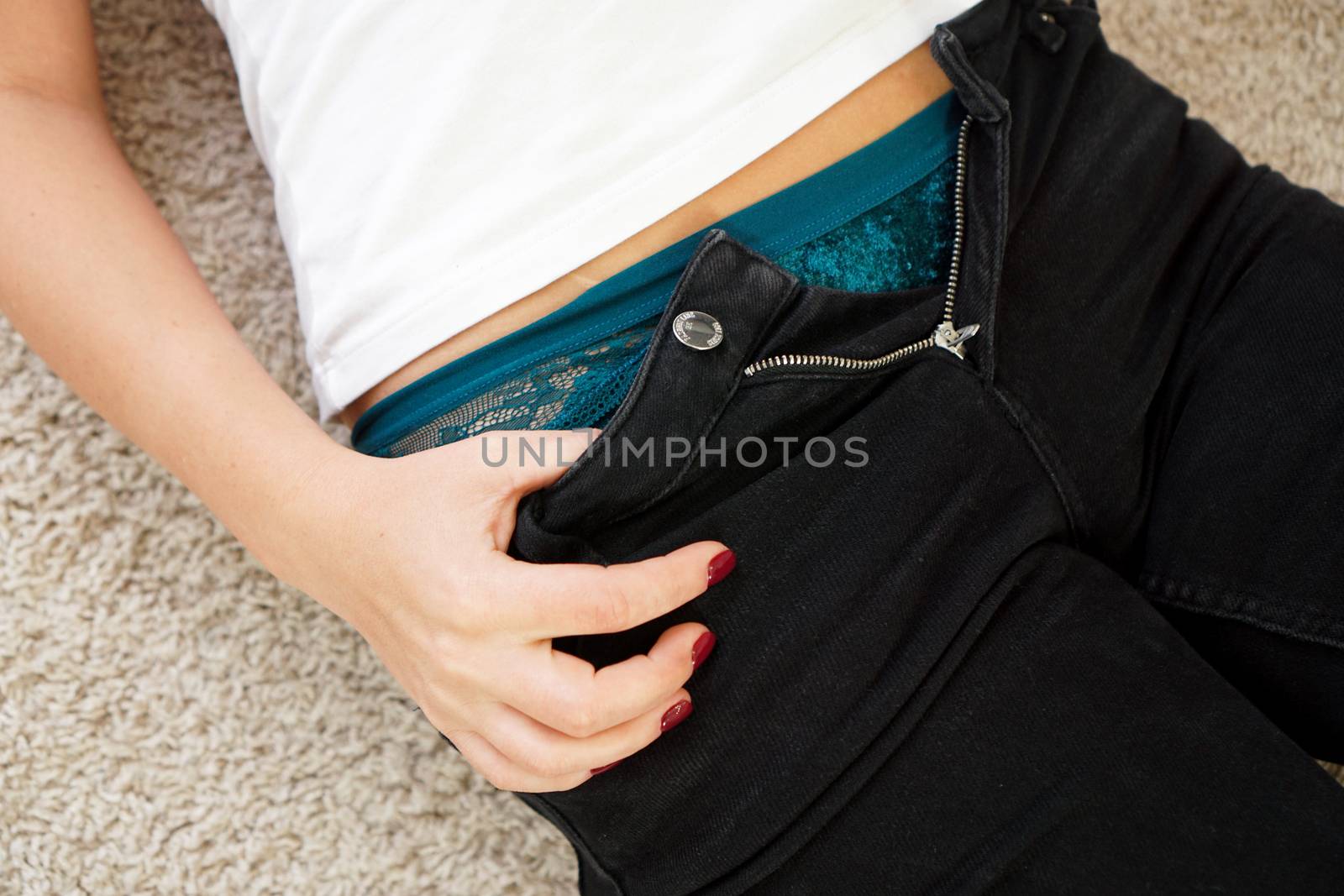 Girl unbuttoned jeans, close-up hands by natali_brill