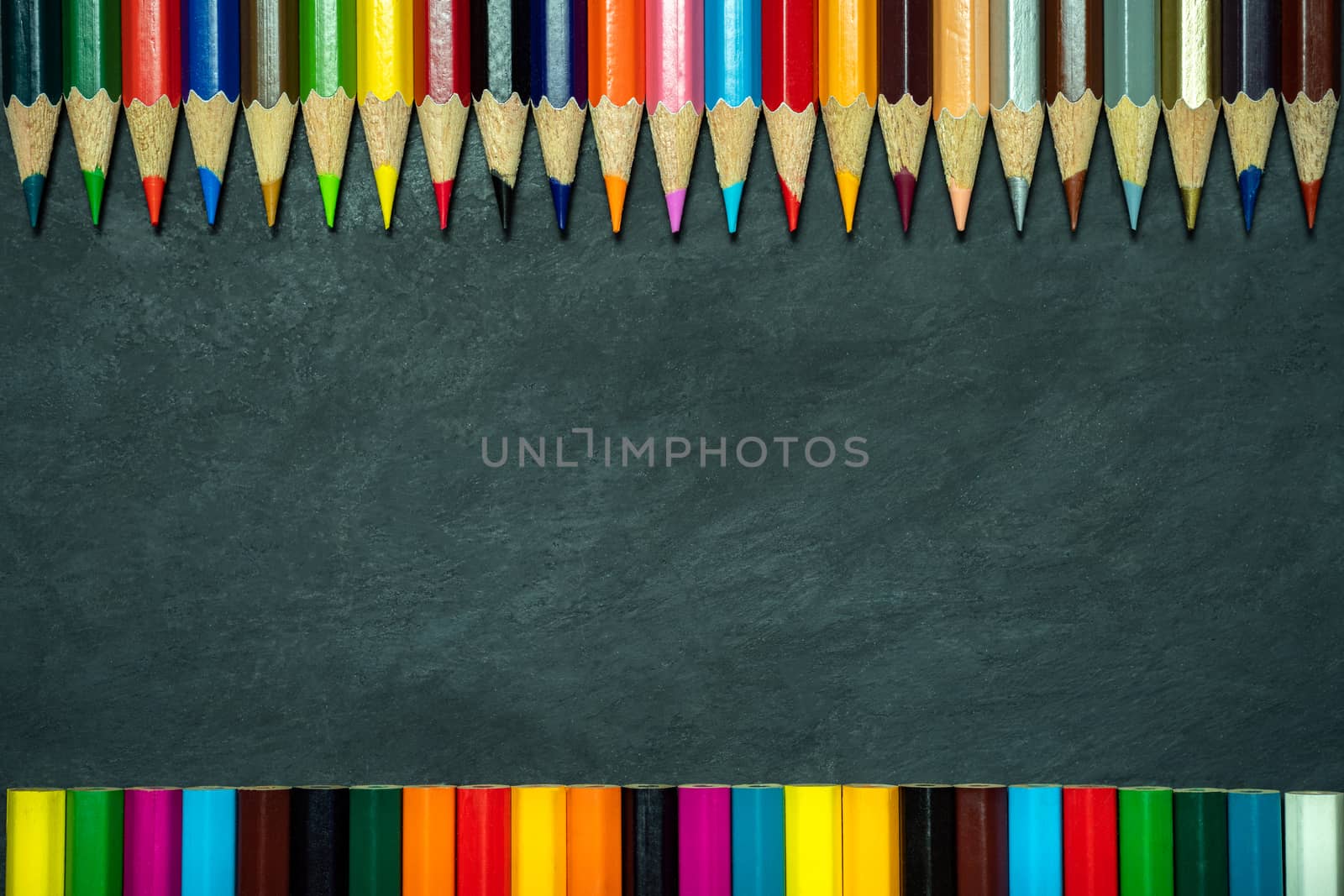 Colored pencils on chalkboard background. by SaitanSainam