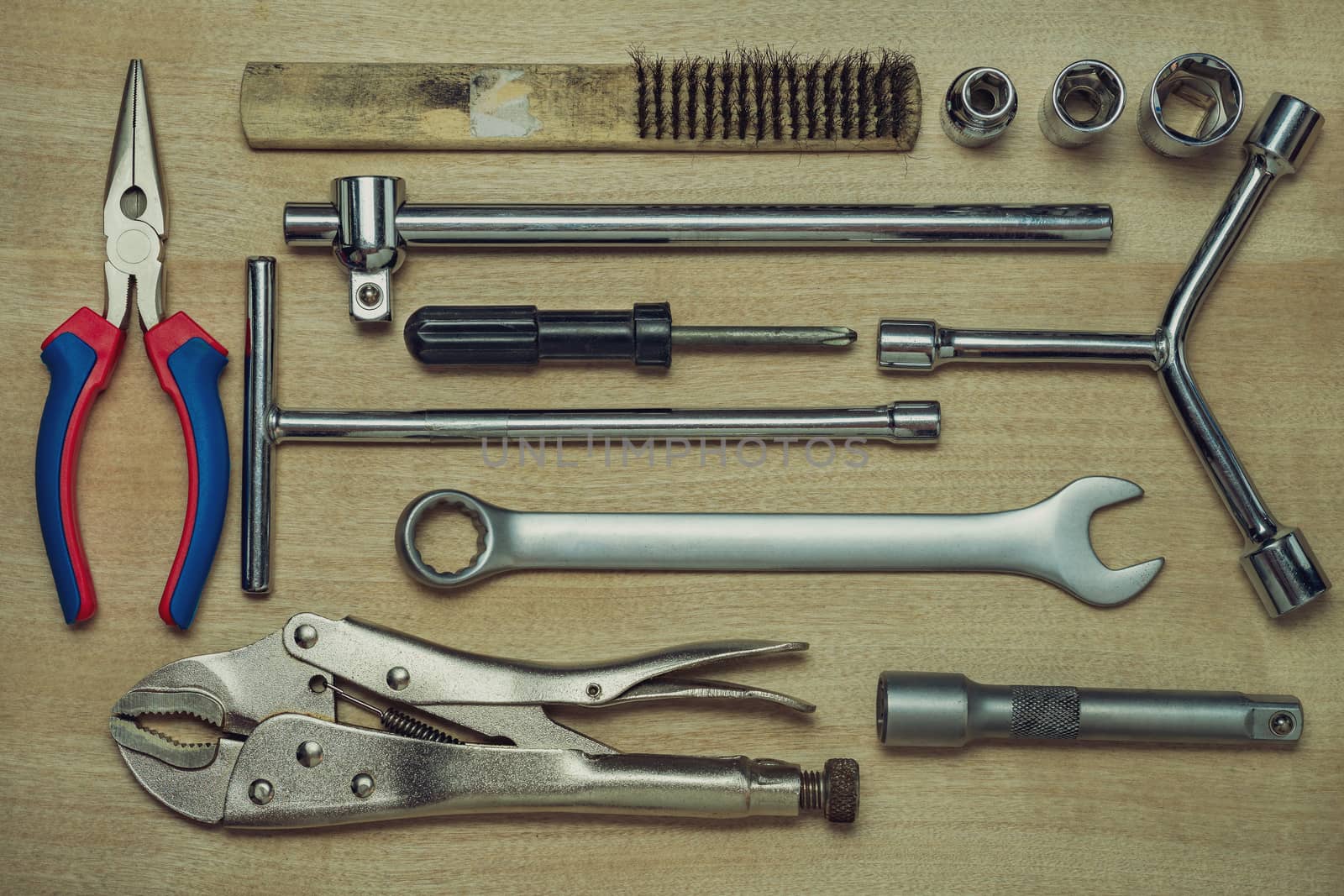 Set of many hand tools on brown wooden floor. Top view of craftsman tool on wooden table background. Top view and full frame. Concept of technician or engineer.