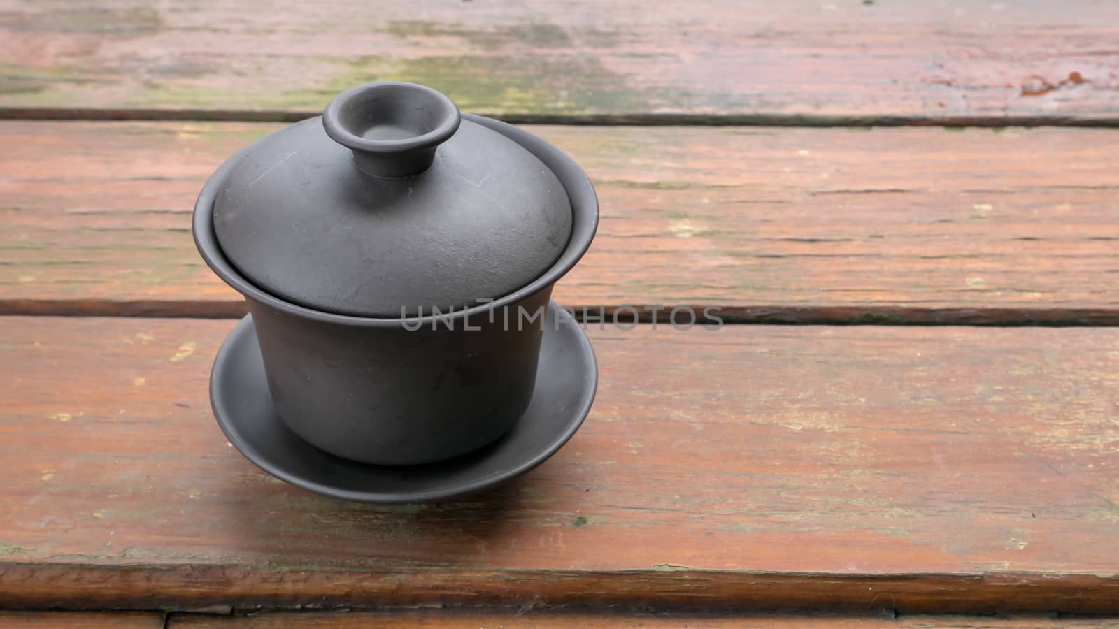 The classic Taiwanese tea cup on old wooden table.