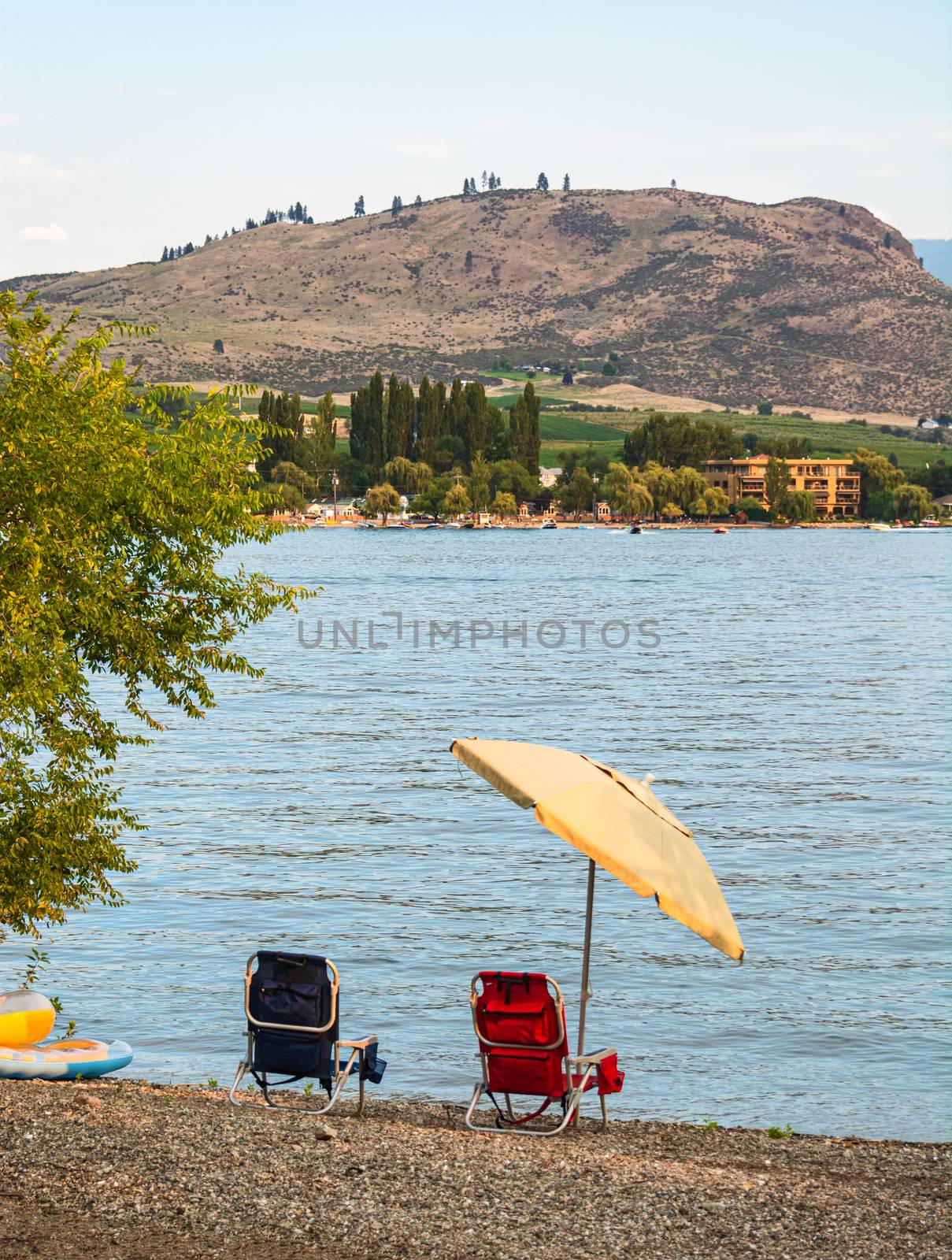 Small tourist camp with a lake overview on warm summer evening. by Imagenet