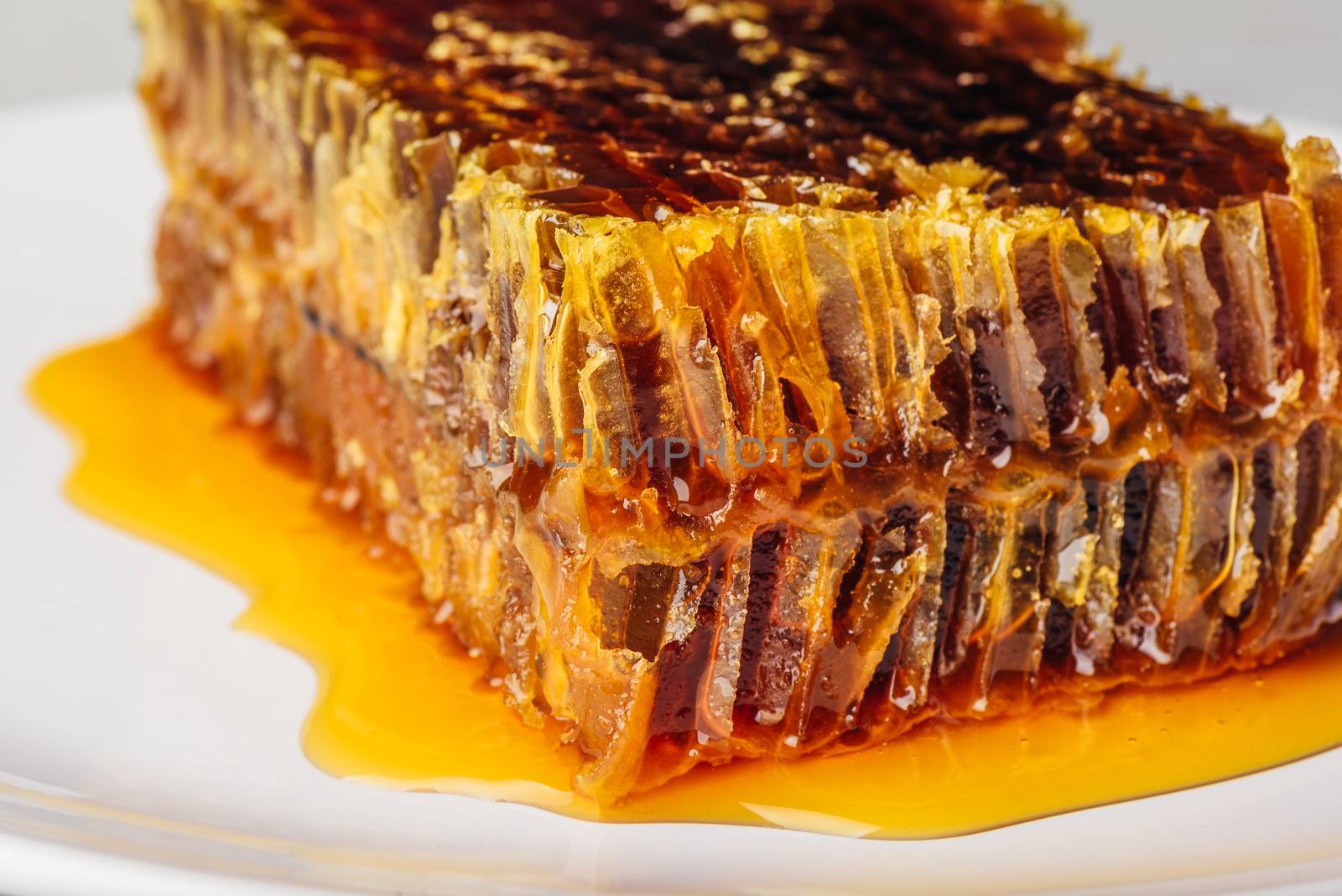 Close-up of delicious honeycomb on light background