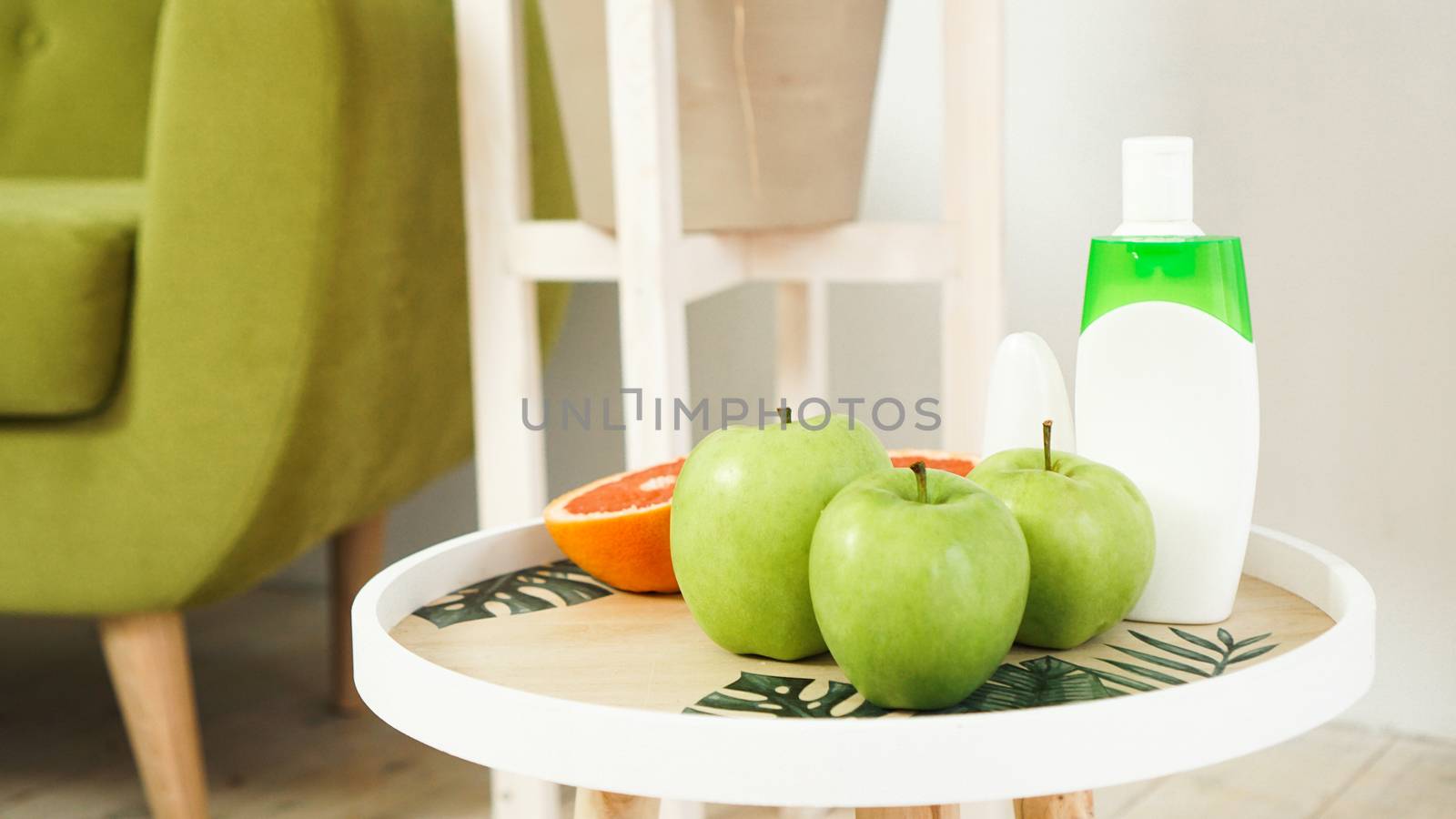Organic orange and green apples on the natural wooden table. Selective focus. Health food, cosmetic and spa concept
