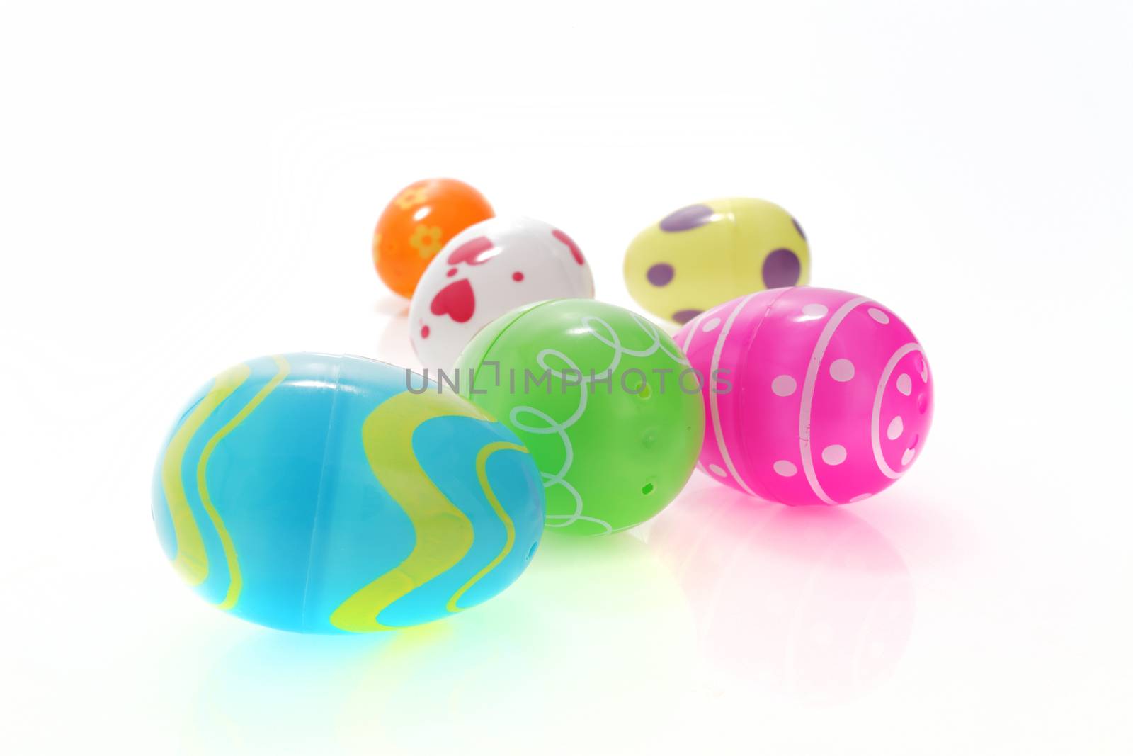A set of colorful Easter egg toys on white with selective focus and shallow depth of field
