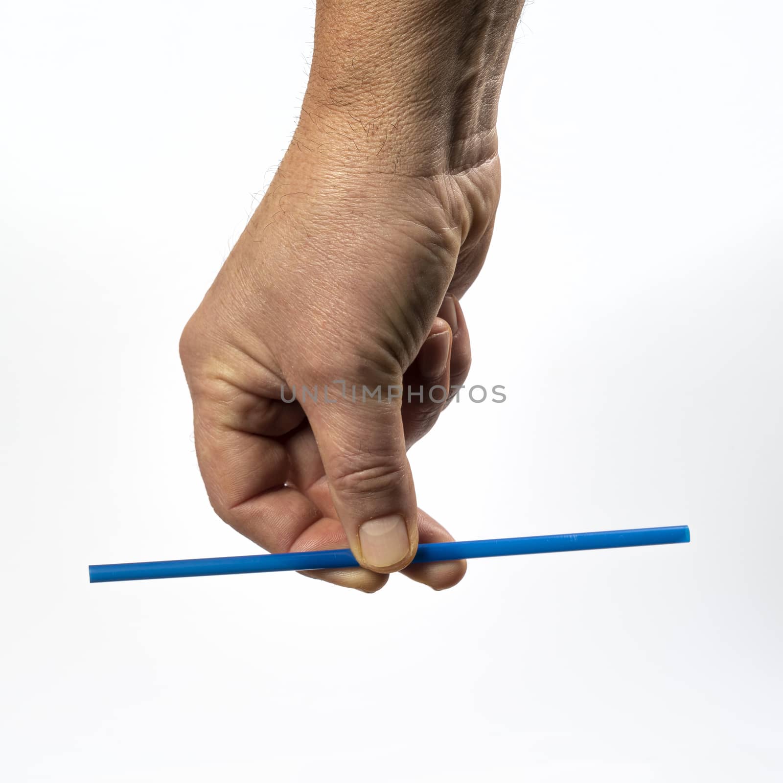 colored plastic straw in hand