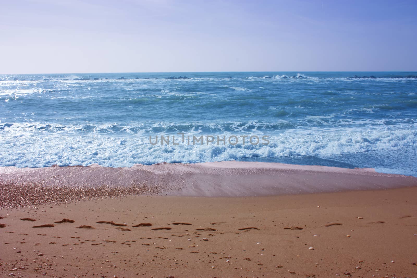 A winter beach with rough seas with cold and dull colors in the Versilian Riviera in italy