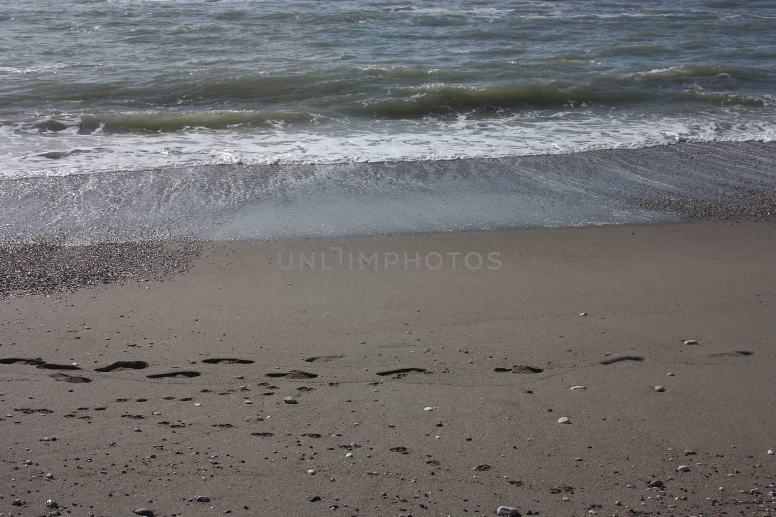 A winter beach with rough seas with cold and dull colors in the Versilian Riviera in italy