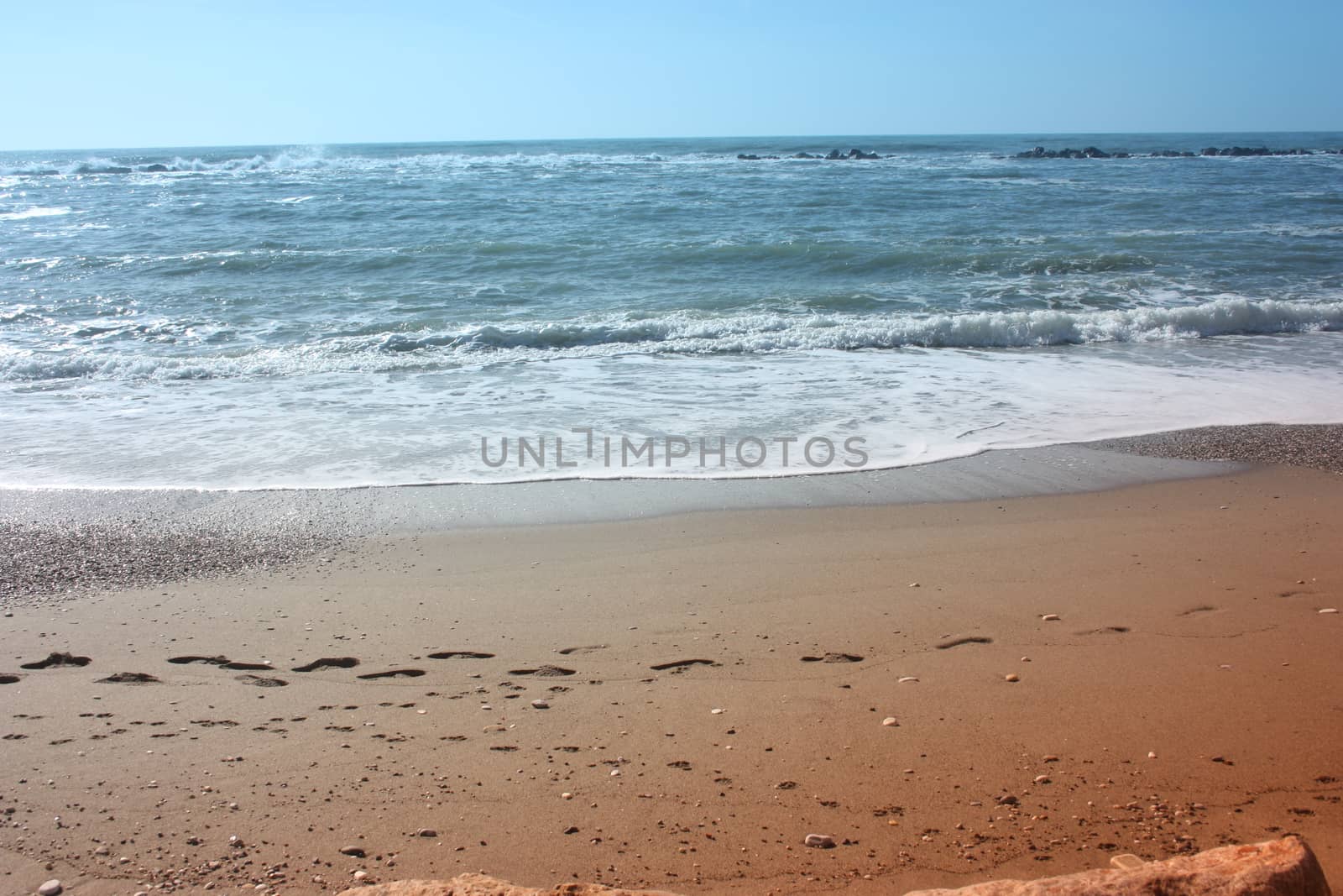 A winter beach with rough seas with cold and dull colors in the Versilian Riviera in italy