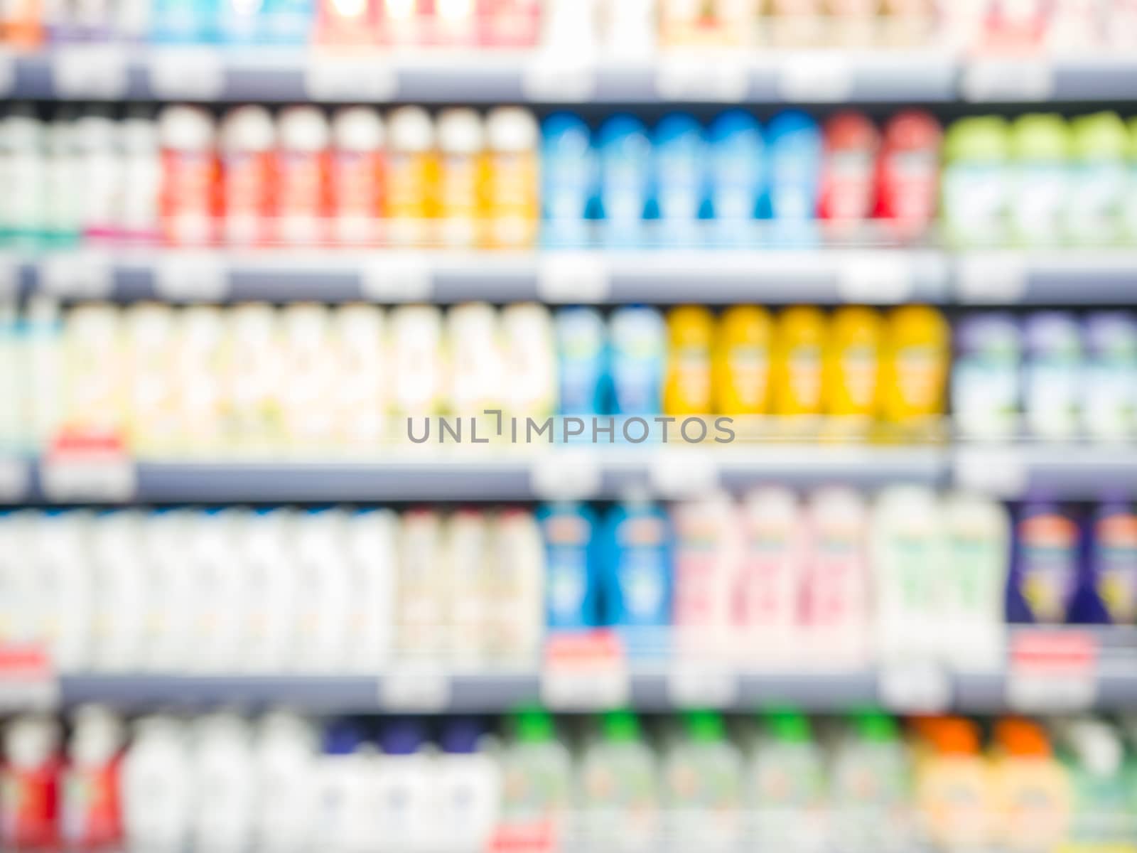 Blurred colorful supermarket products on shelves by fascinadora