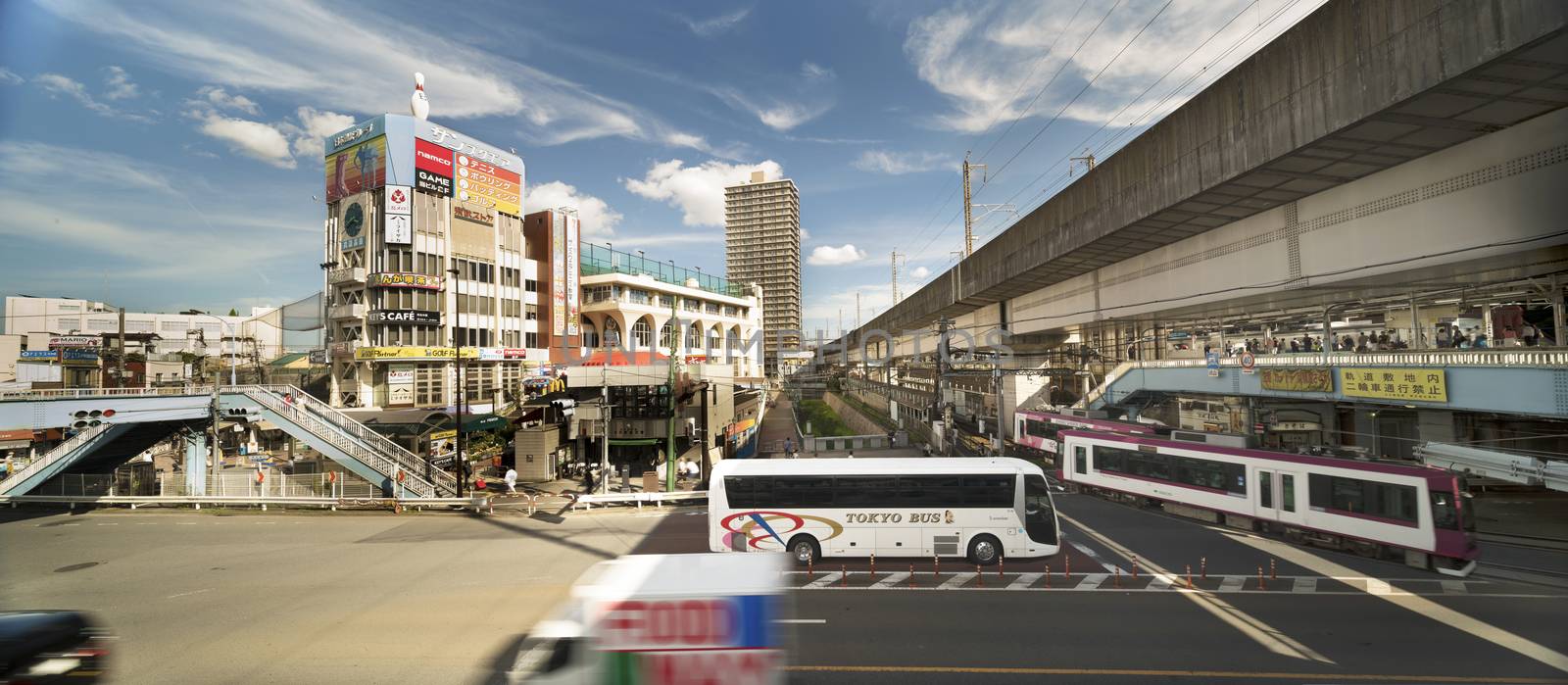 Oji station JR Keihin Tohoku Line in the Kita district, north of Tokyo. The pedestrian walkway spans the intersection of Meiji Avenue where the Ojiekimae station of the Toden Arakawa tram line is famous for its retro style.