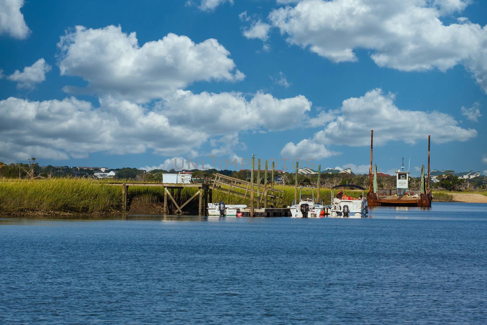 People Relaxing on Boat by Marsh by dbvirago