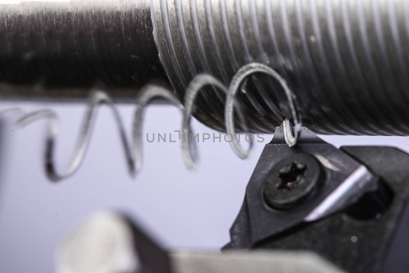 close up of metal cutting on lathe with metal carving off