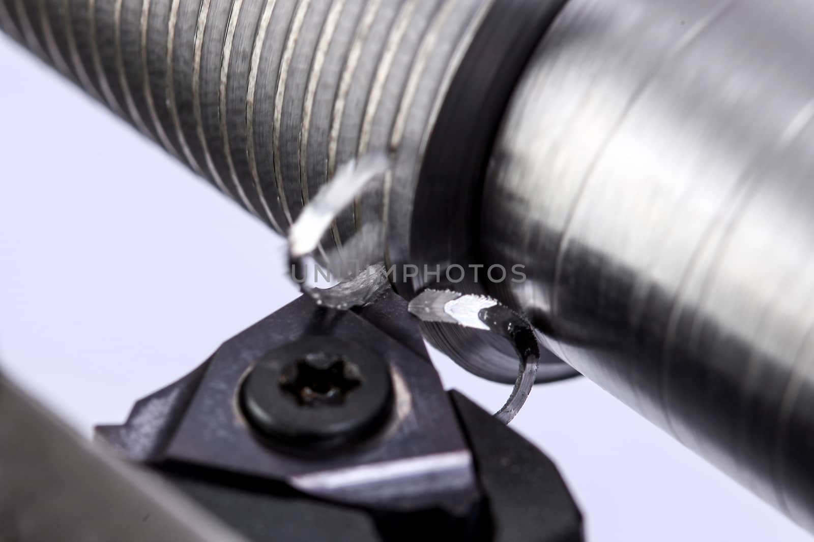 close up of metal cutting on lathe with metal carving off