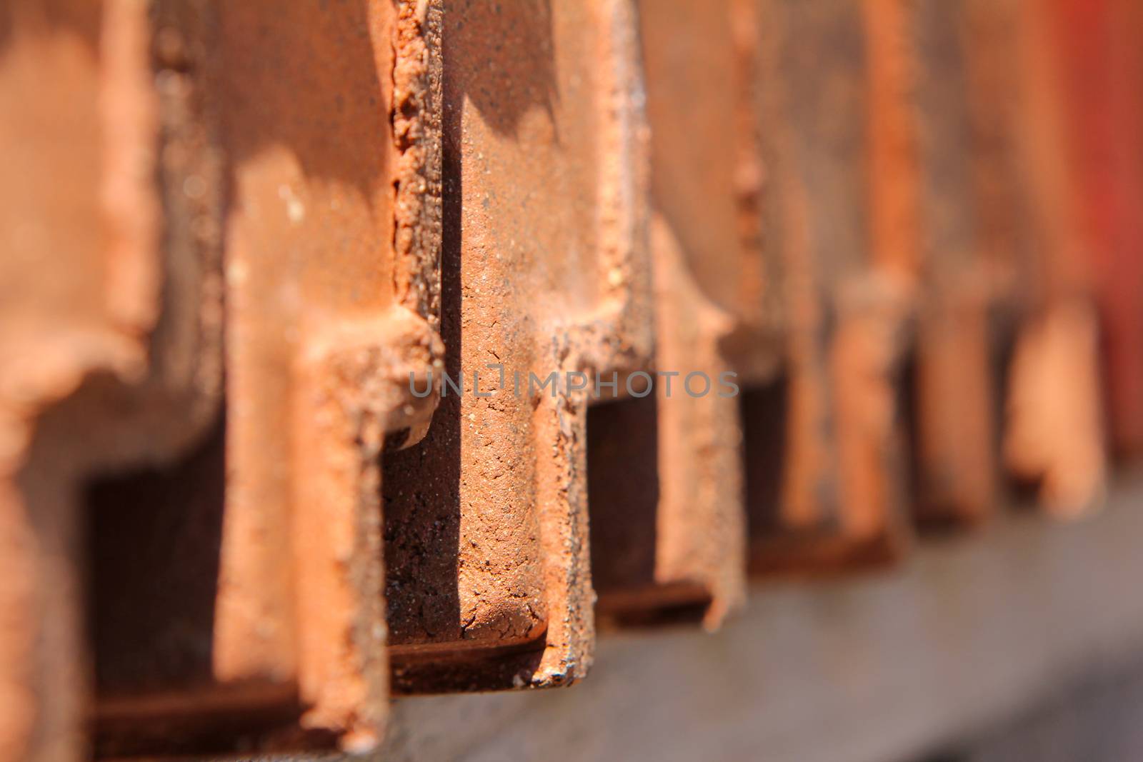 red roofing tiles lined up in a row. Close up of roofing times